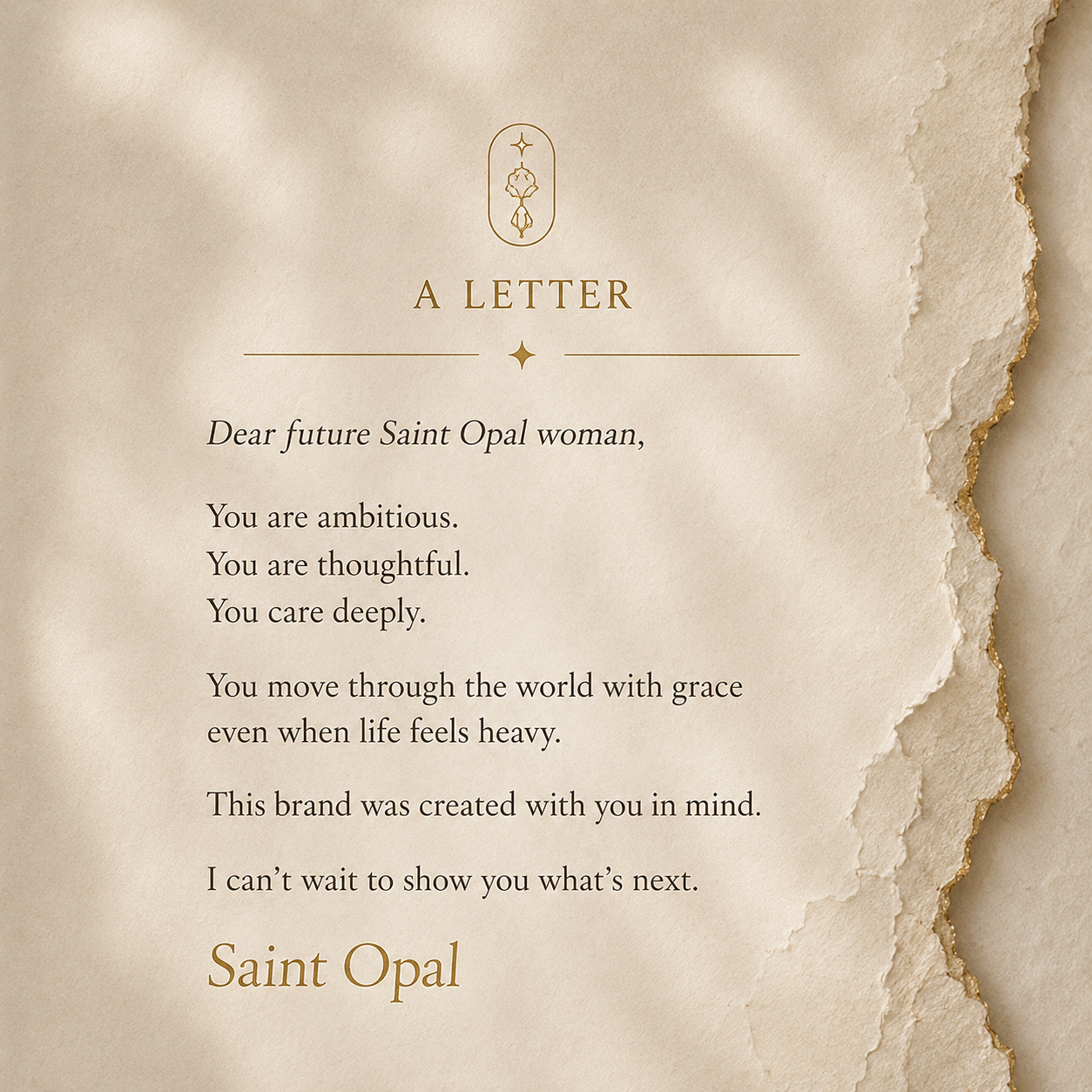 A letter on torn beige paper with gold-edged edges, featuring a gold emblem at the top and text addressed to a future Saint Opal woman, praising her ambition, thoughtfulness, deep care, grace, and creation of the brand with her in mind.