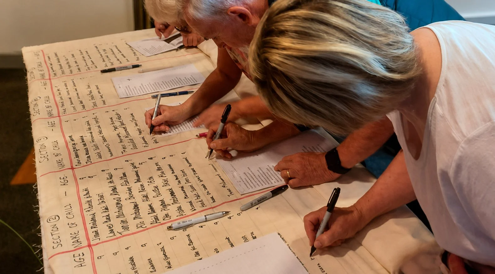 People writing names of murdered children of Gaza