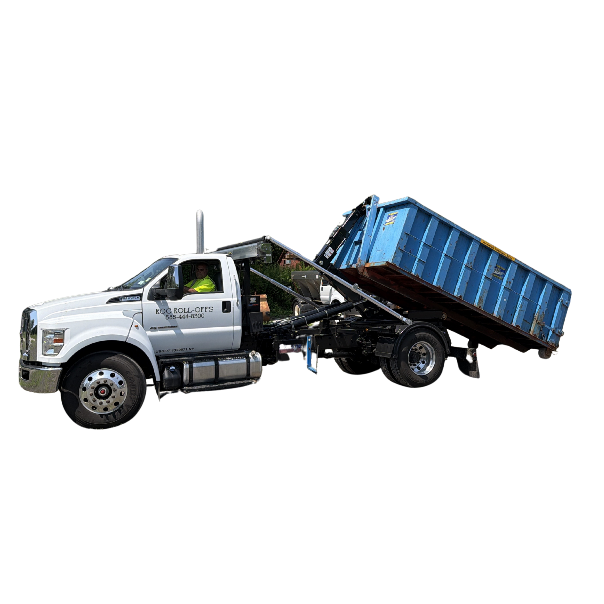A white dump truck with the words 'ROCK ROLL-OFFS' and a phone number on the side, lifting its blue dumpster container to unload debris, with a man in a yellow safety vest operating the truck.