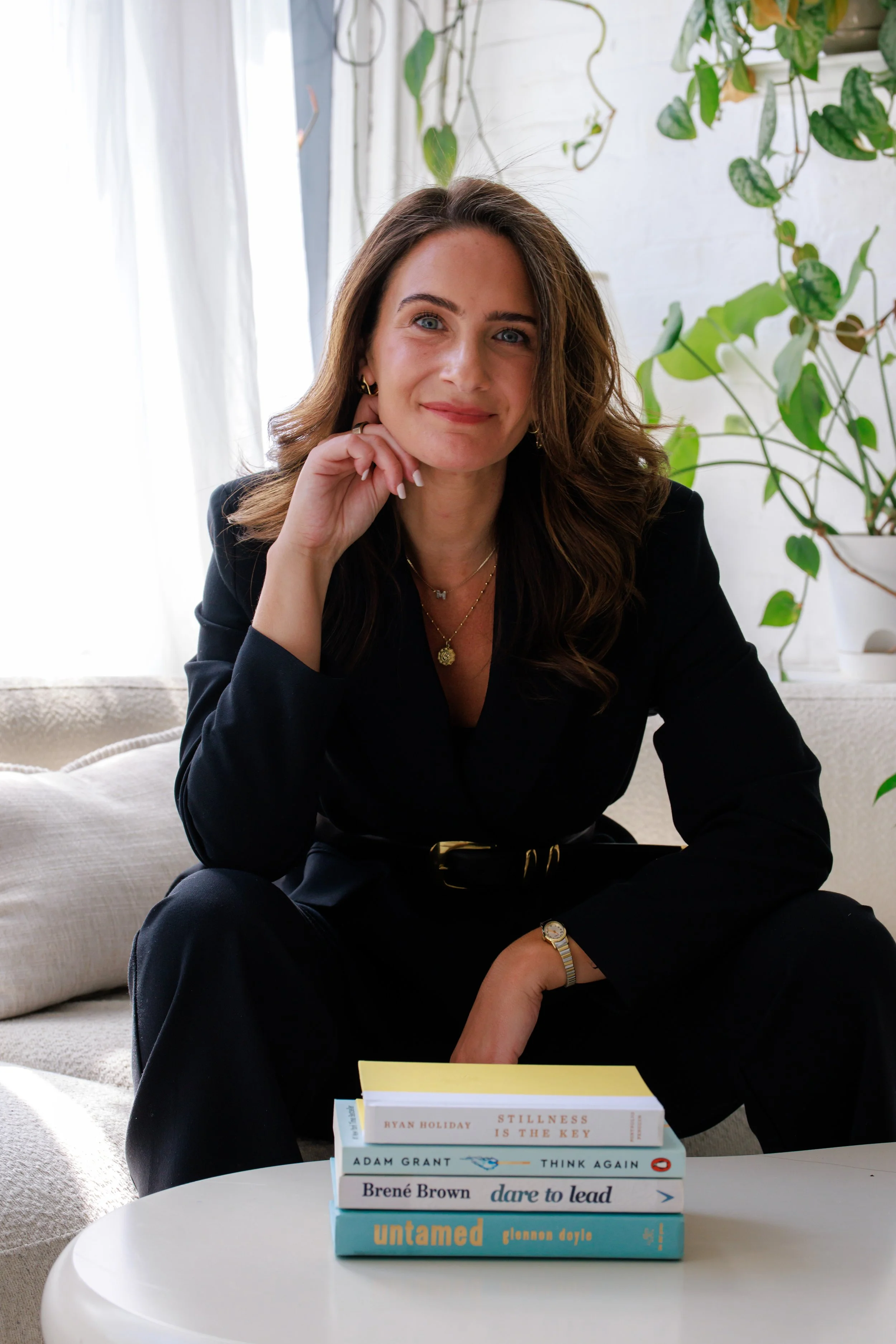 Five books stacked horizontally, with titles including "Stillness is the Key," "Think Again," "Dare to Lead," and "Untamed." Strategic executive advisor with books on leadership, business and strategy. data-driven outcomes.