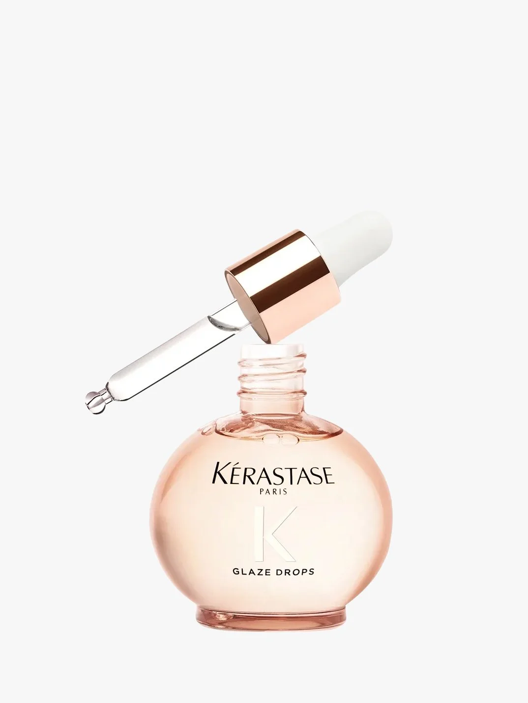 A bottle of Kérastase Paris Glaze Drops hair serum with a dropper cap resting on top.