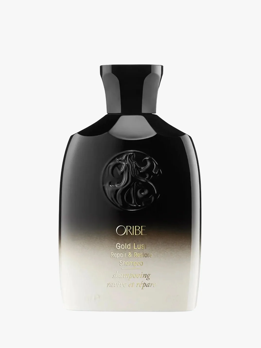 A black bottle of Oribe Gold Lust Repair & Restore Shampoo with a gold gradient at the bottom and a black embossed emblem on the front.