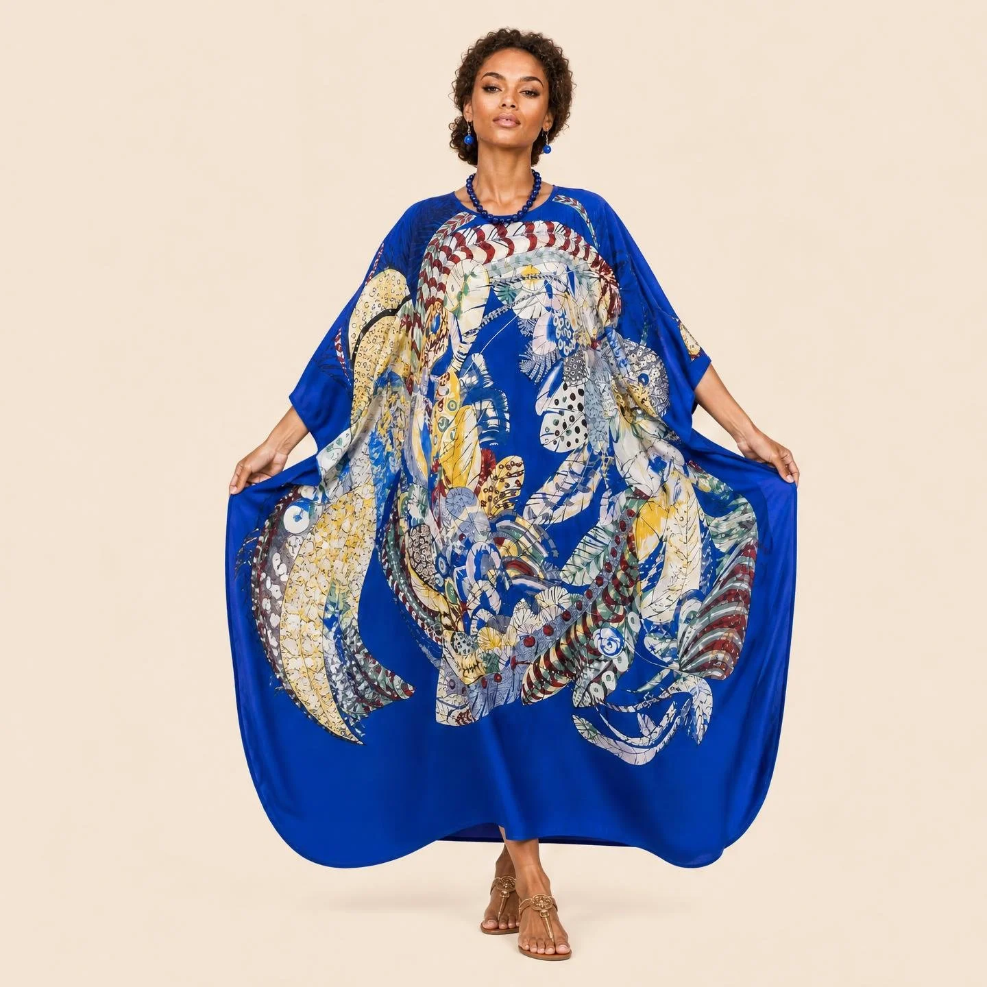 Sapphire Shell resort wear long silk kaftan in cream and gold shells on deep sapphire
