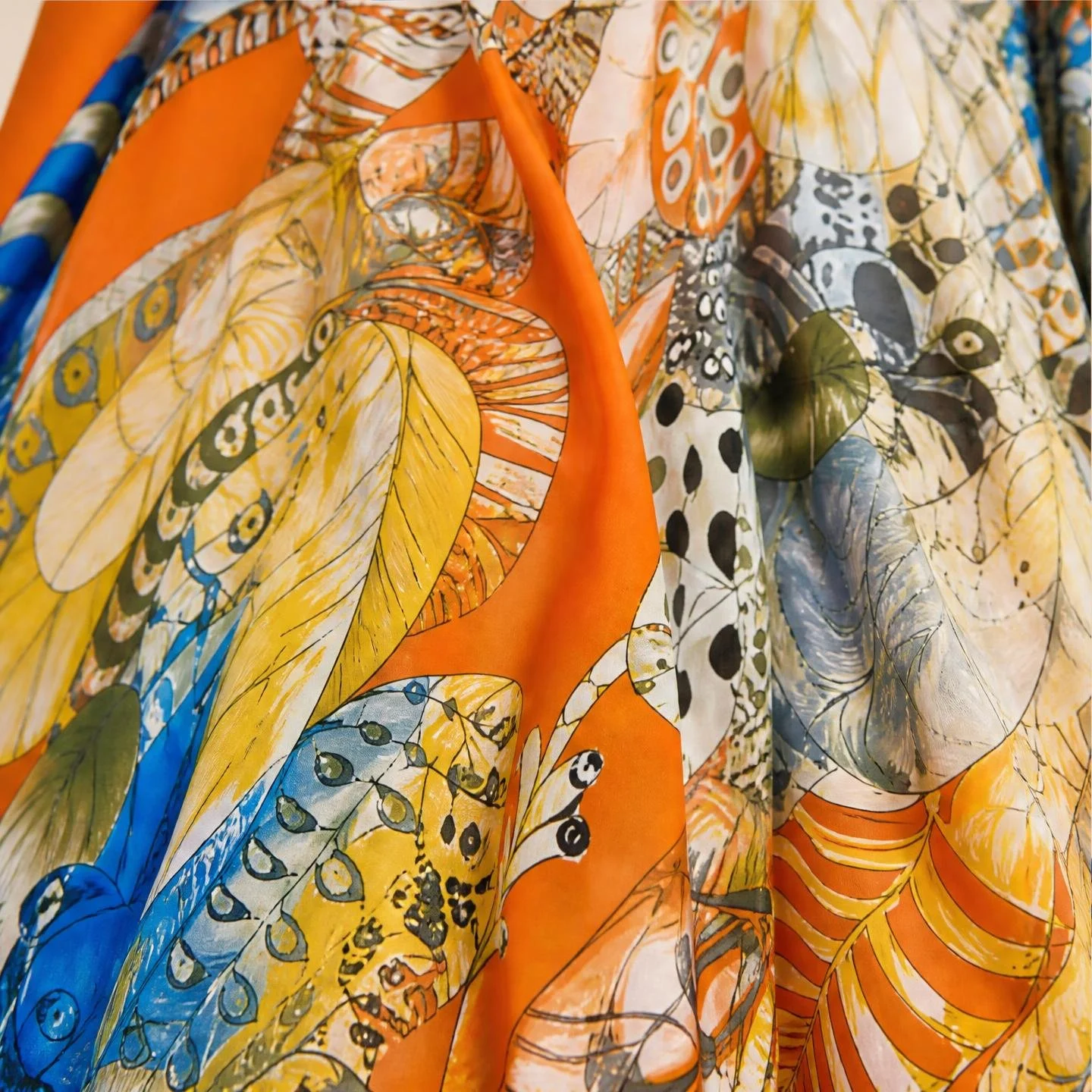 Sunset Plume resort wear long silk kaftan in marigold and chartreuse feathers on burnt orange