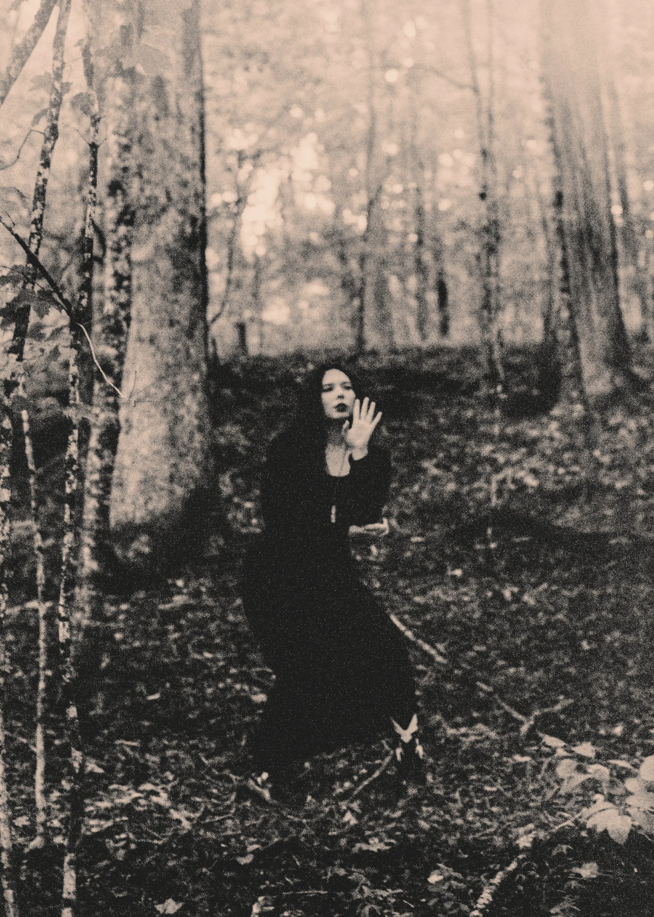 black and white film photograph of singer in woods