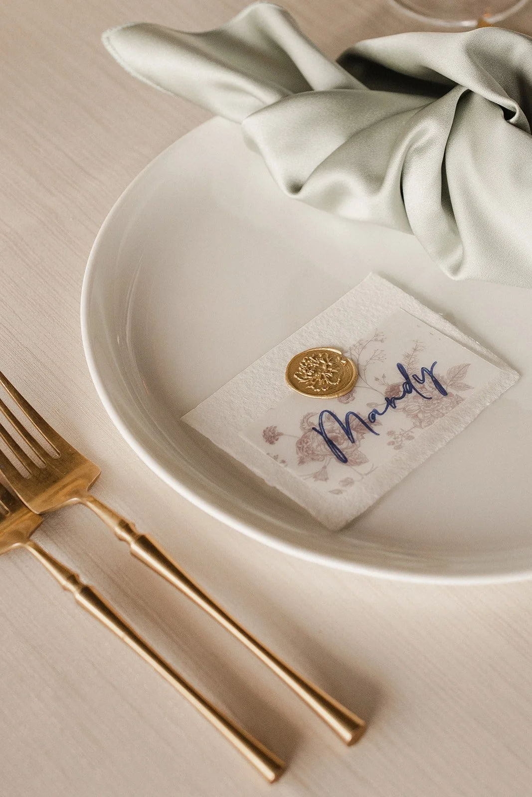 Place setting with gold wax seal name card - partial wedding planning in Omaha by Renae Events