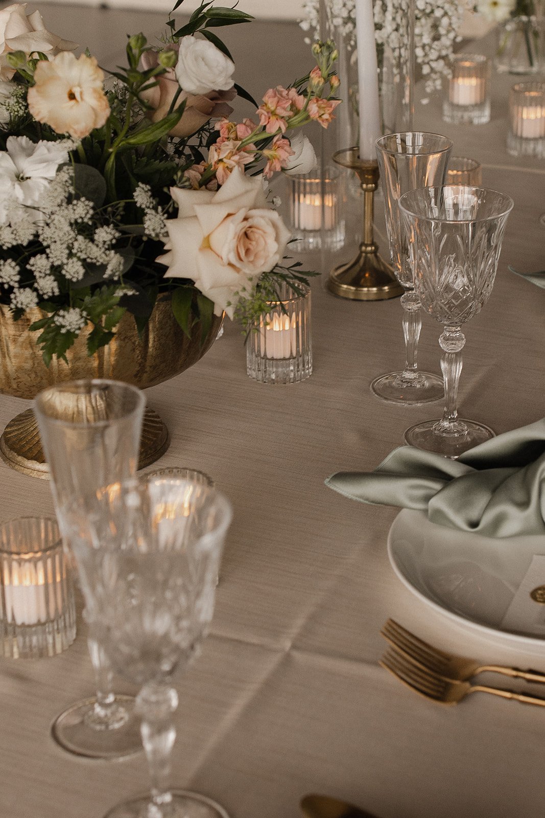 Floral wedding reception tablescape with gold flatware - Renae Events, Omaha wedding planner
