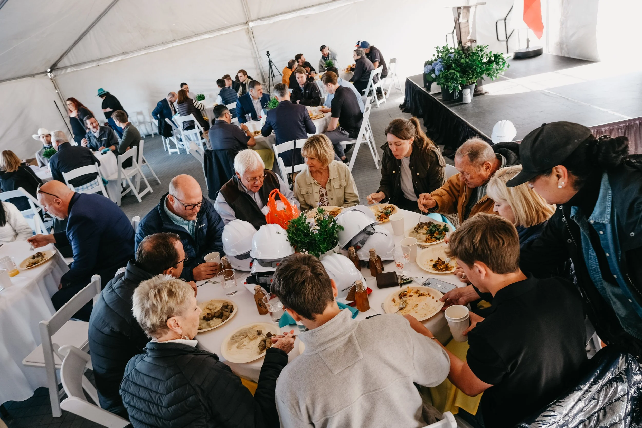 Clearway Energy Kent County Solar Farm Ribbon Cutting.  Guests enjoying lunch under a tent for sun and wind protection.