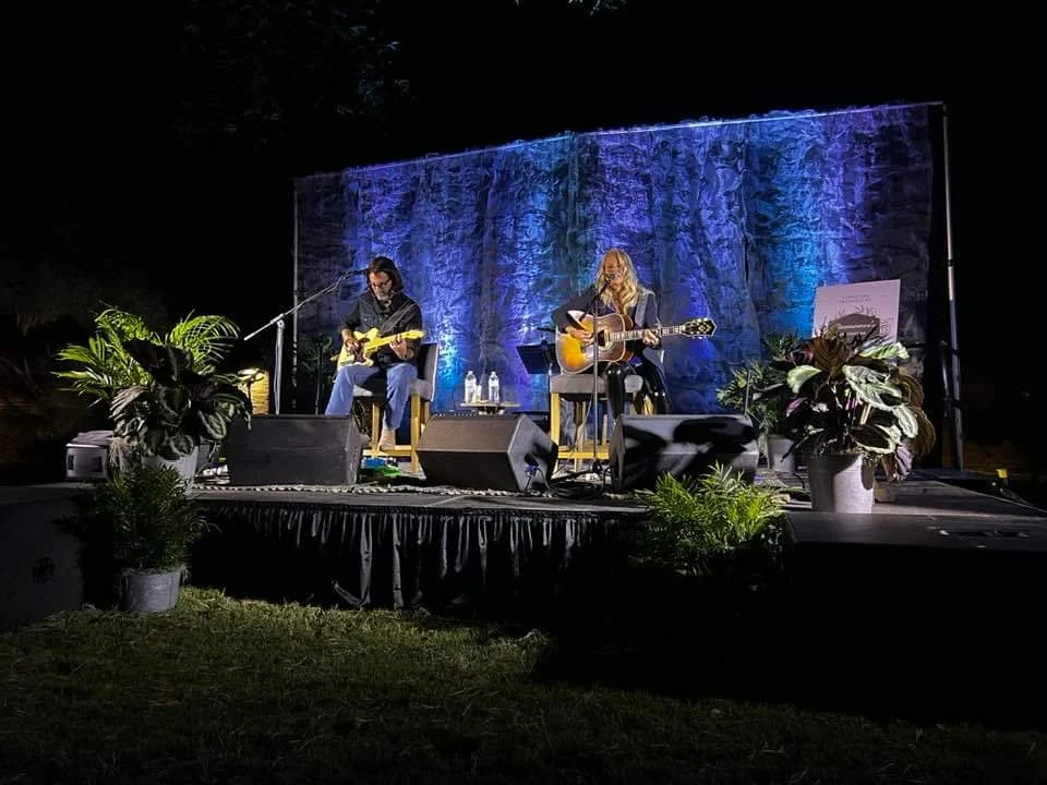 Covenant House Concert- Strawberry Wine being performed by Dena Carter.  Live plants and striking on-brand lighting frame her performance.