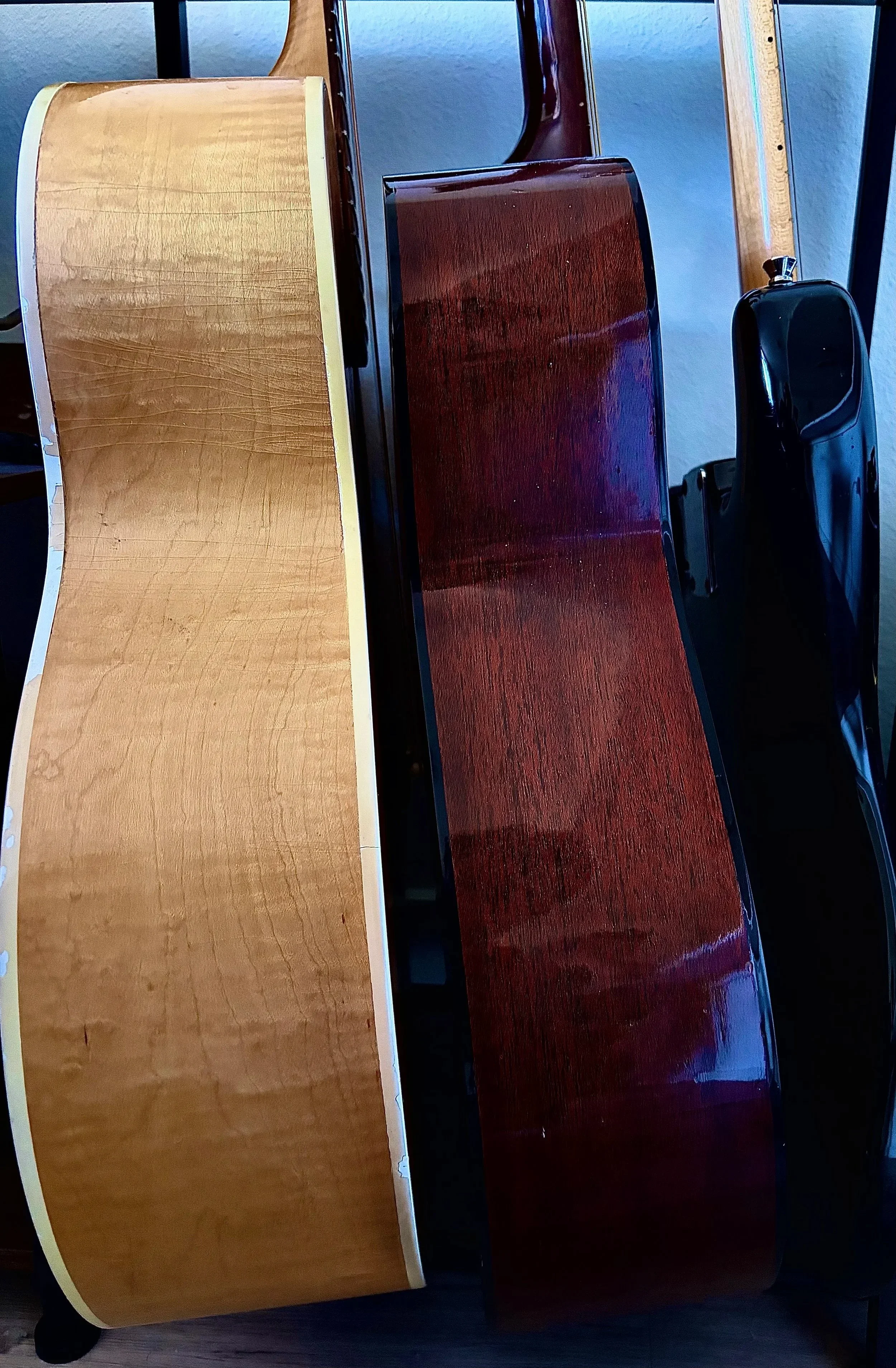 Three guitars displayed in profile at Bennett Instruments