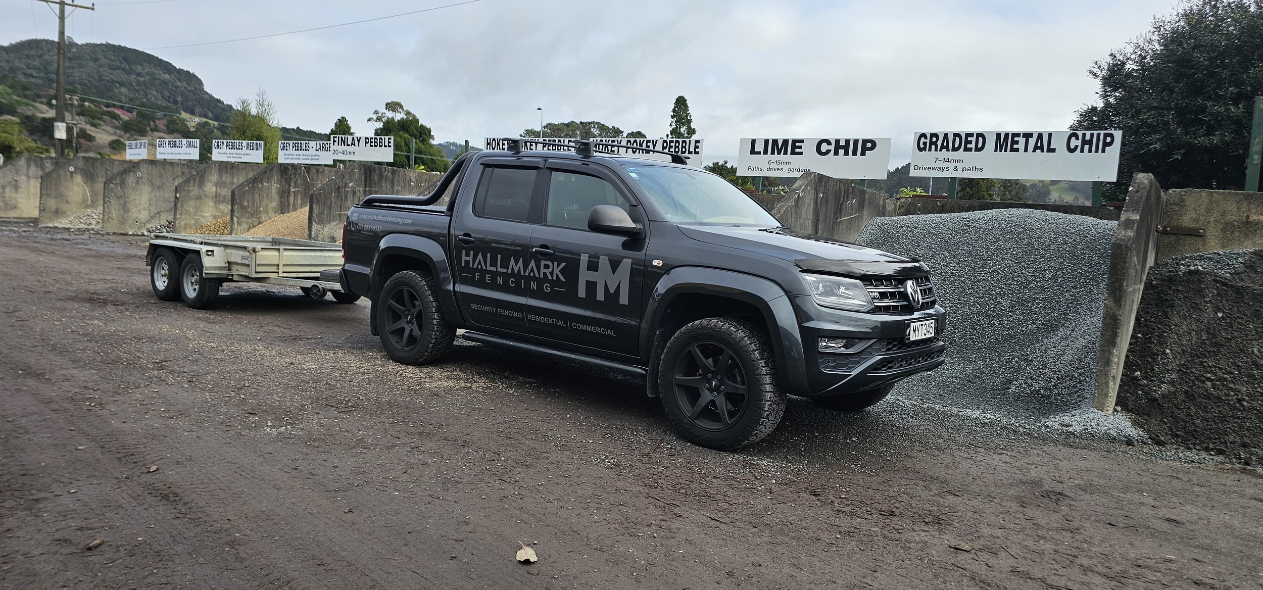 Hallmark Fencing installer fitting an aluminium fence panel