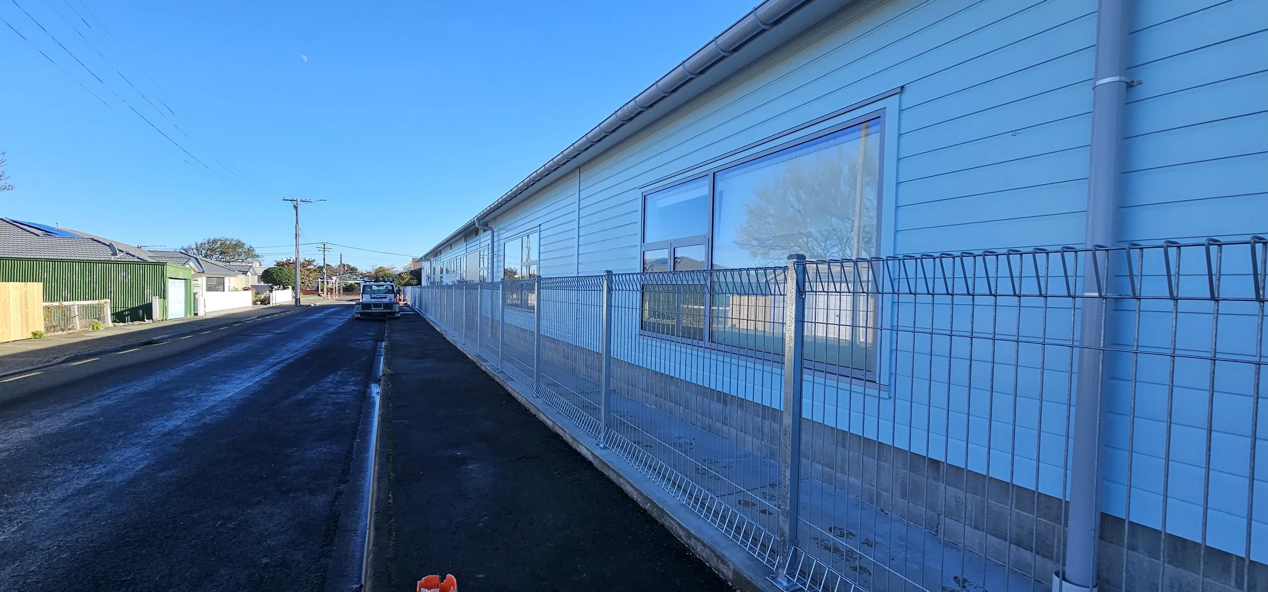 Industrial security fencing with anti-climb topping