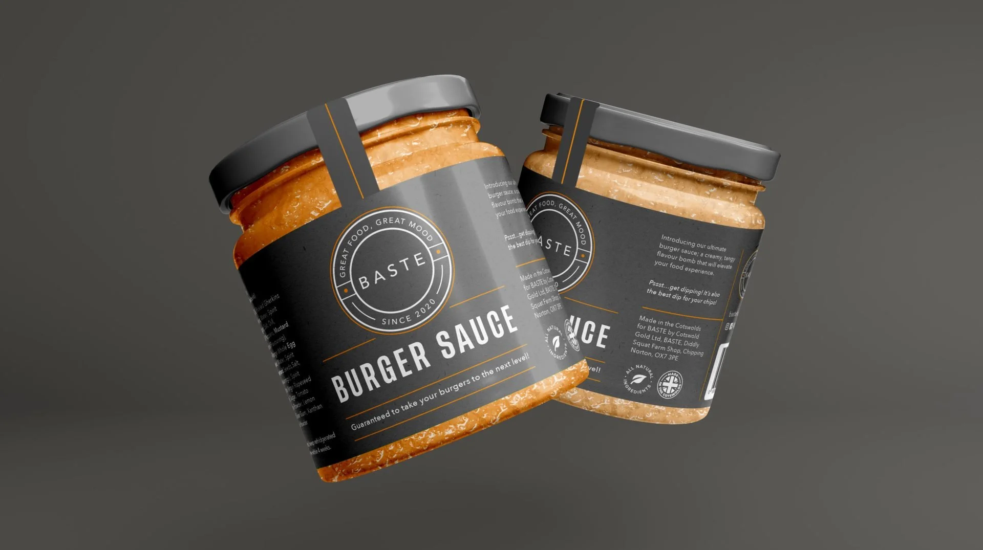 Two jars of Baste burger sauce with black labels and gray lids, set against a dark background.