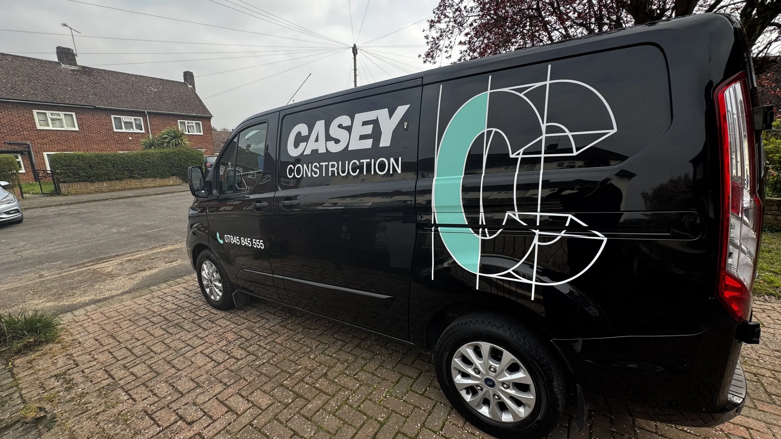 Casey Construction Van signage graphics installed large logo.jpg
