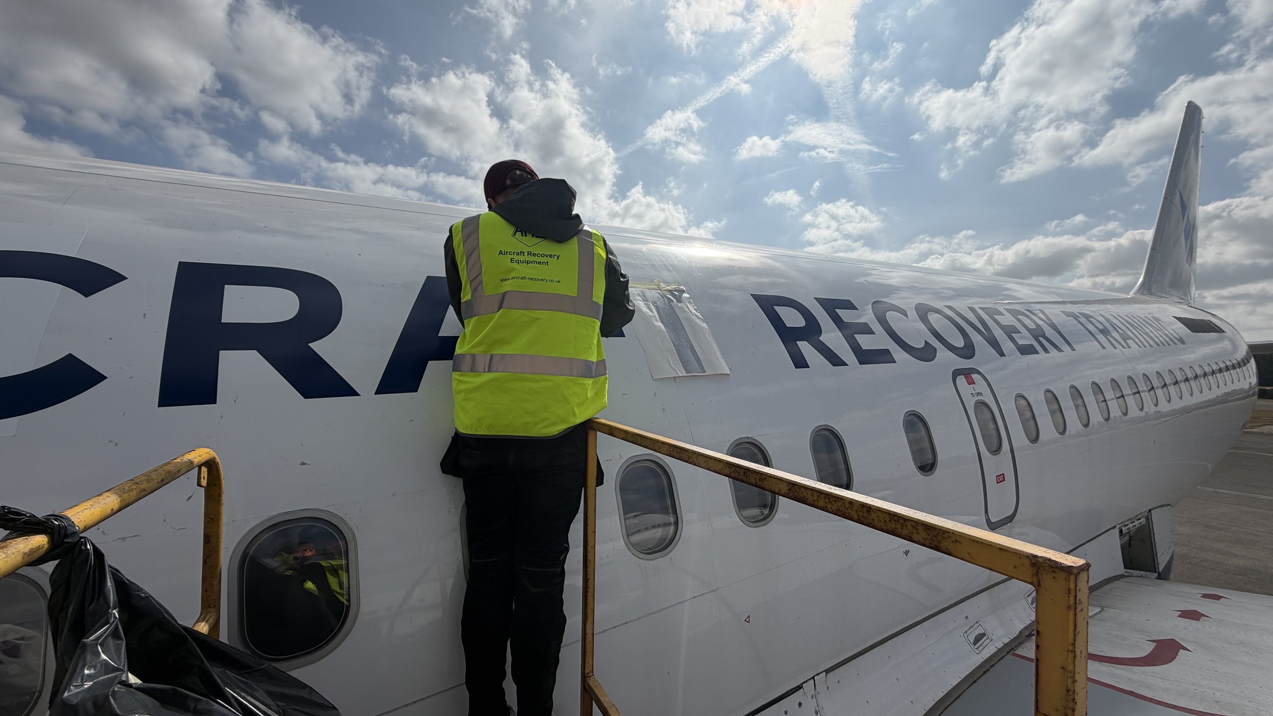 AMS Aircraft Recovery branded aircraft tail and fuselage at Cotswold Airport