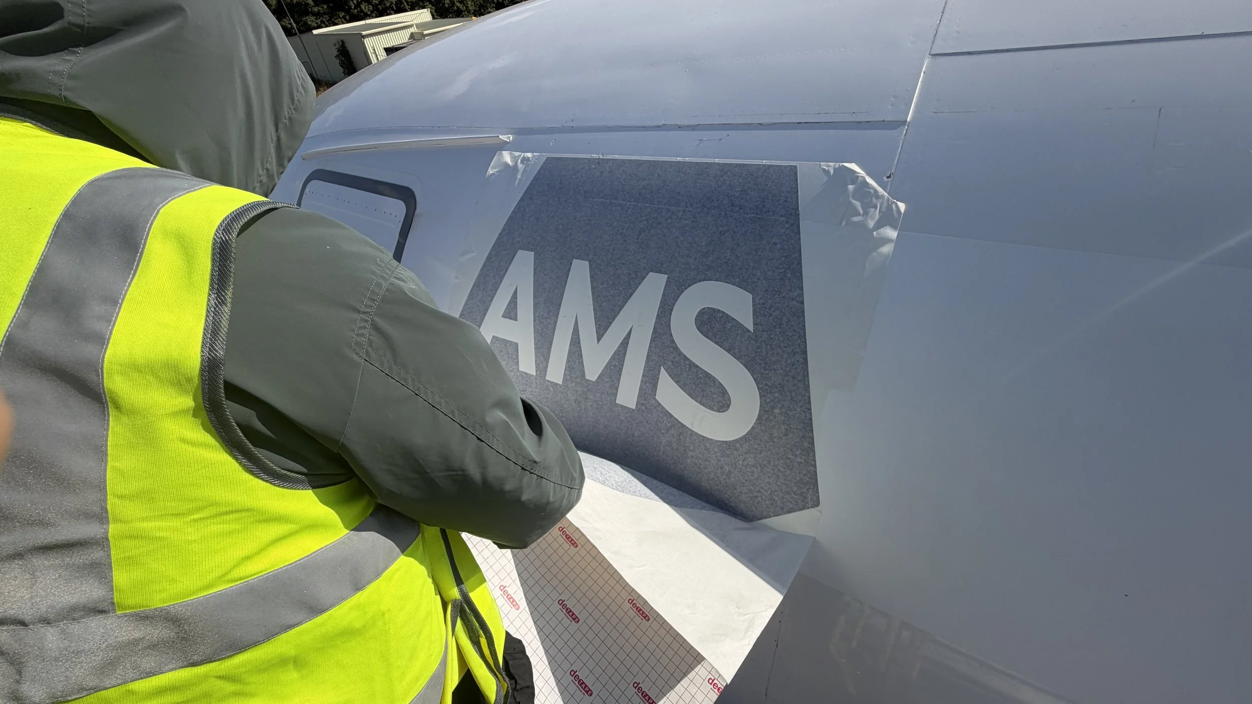 Aircraft recovery training graphics being installed on a passenger aircraft in Gloucestershire