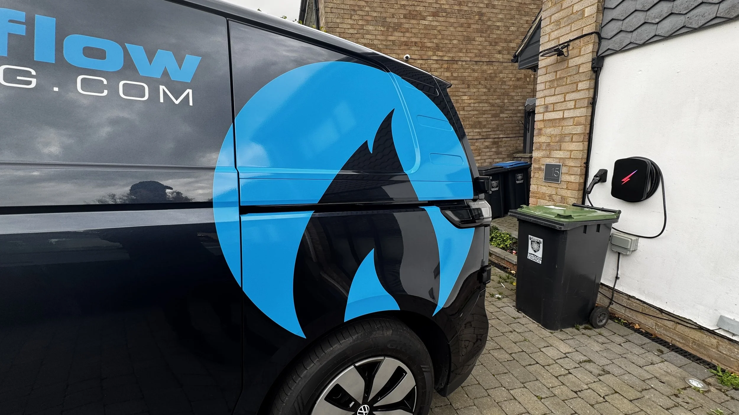 Close-up of oversized blue flame vinyl graphic wrapping around VW ID. Buzz rear panel.JPG