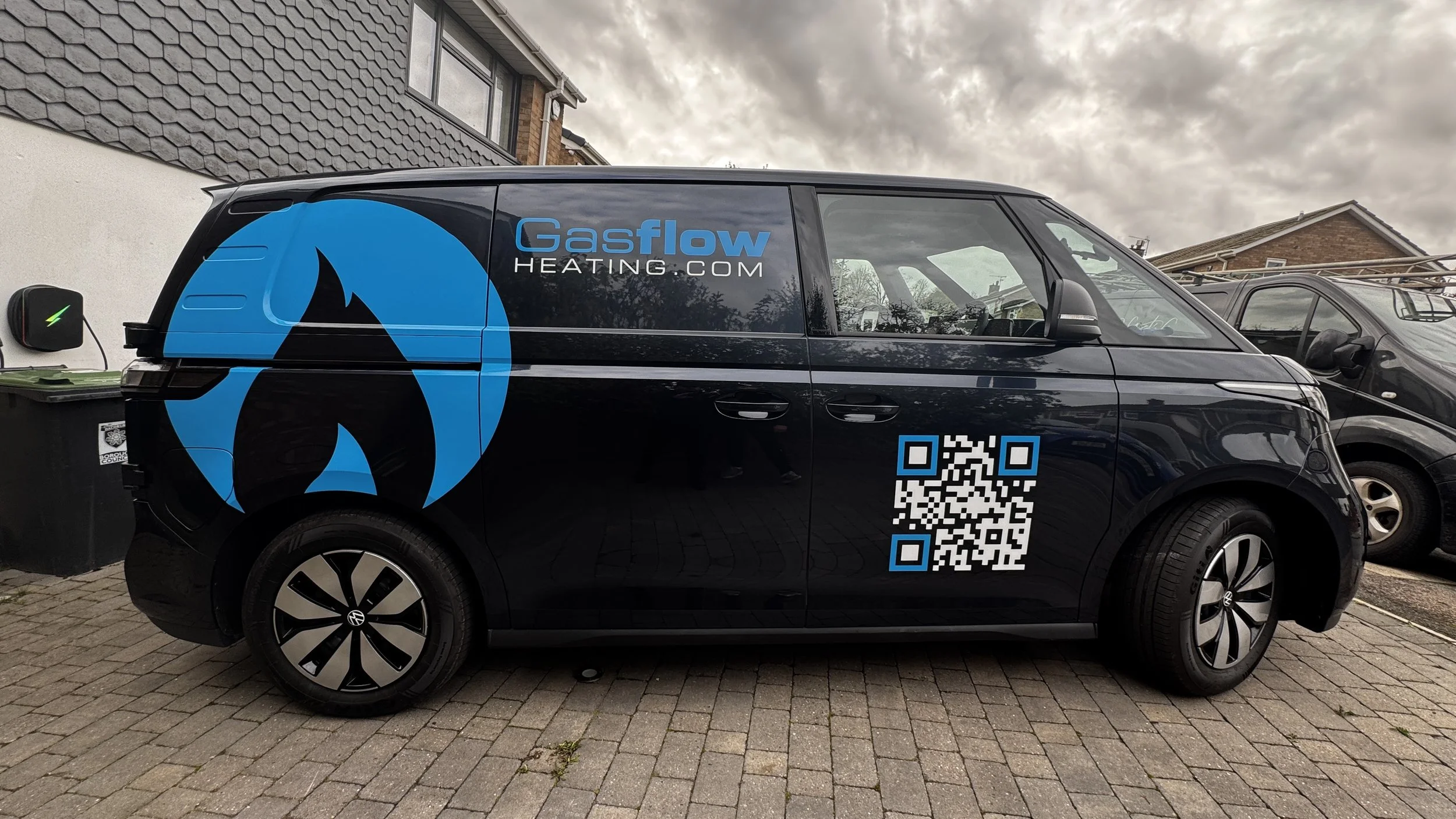 VW ID. Buzz van graphics featuring Gasflow Heating logo, large blue flame and QR code.JPG