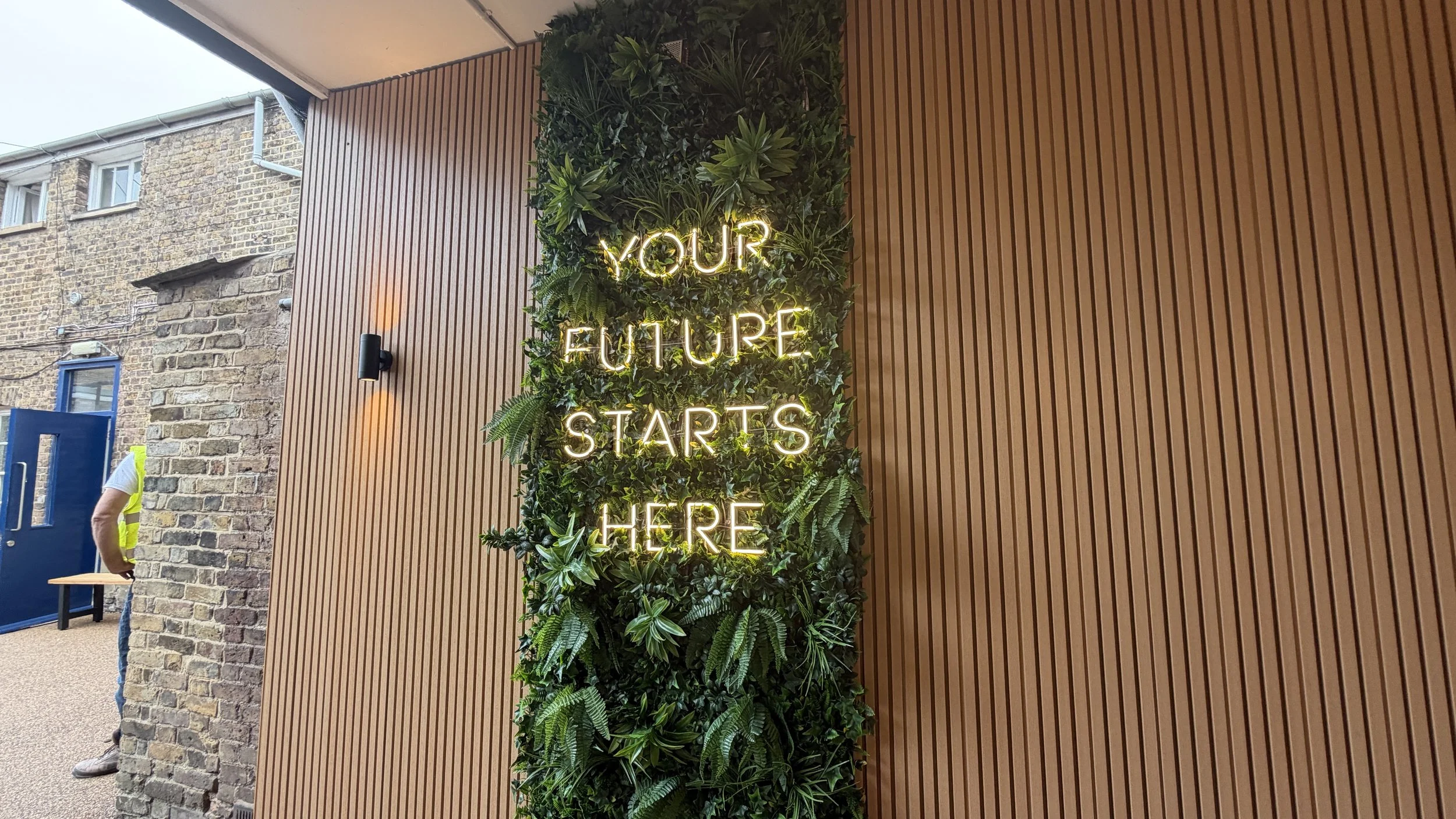Neon-style illuminated school signage installed on brick feature wall in Slough Berkshire.JPG
