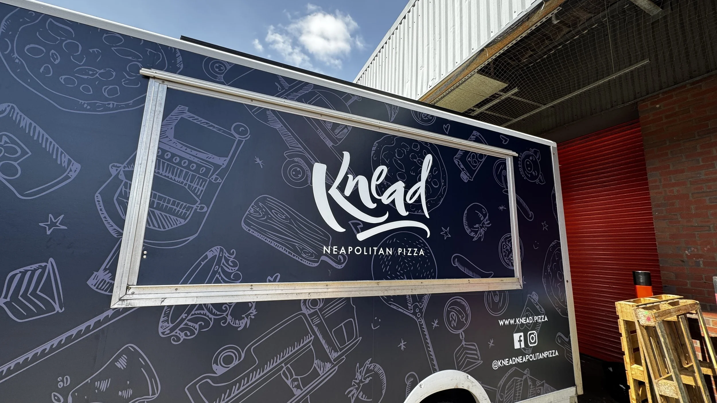 Close-up of Knead Neapolitan Pizza logo and food illustrations on conforming vinyl vehicle wrap.JPG