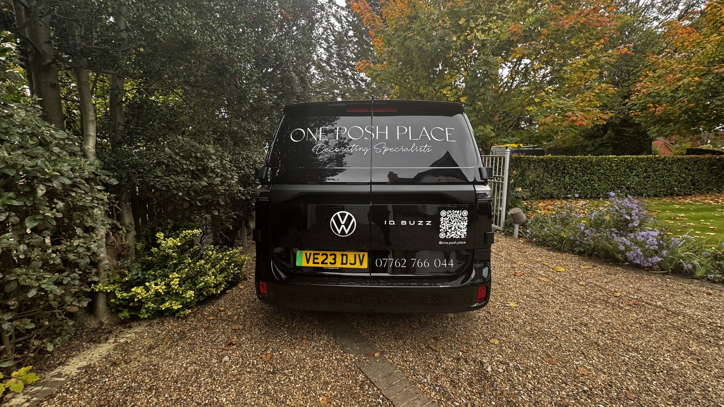 Rear view of One Posh Place VW ID. Buzz with white business logo and vinyl decals.JPG