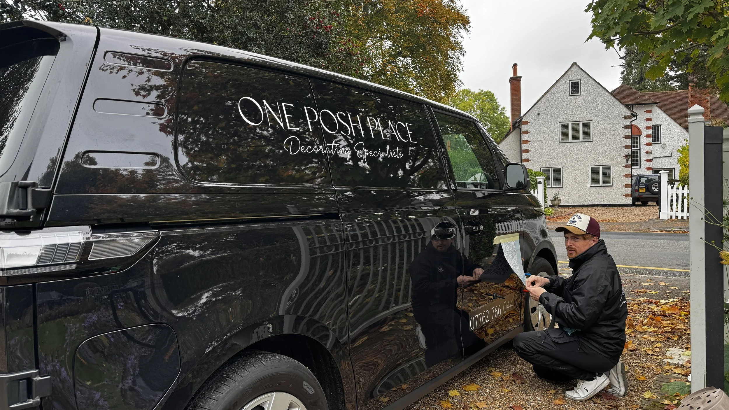 Toy Creative installing white vinyl lettering on One Posh Place VW ID. Buzz in Gerrards Cross.JPG