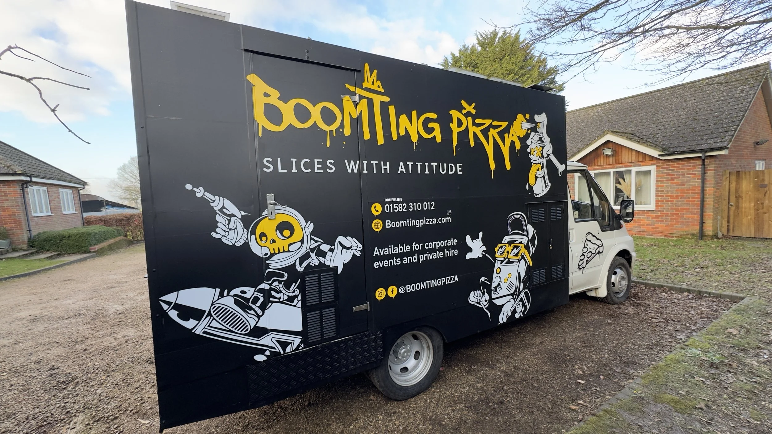 Front-side angle of Boomting Pizza truck showing cab graphic and main branding panel.jpeg