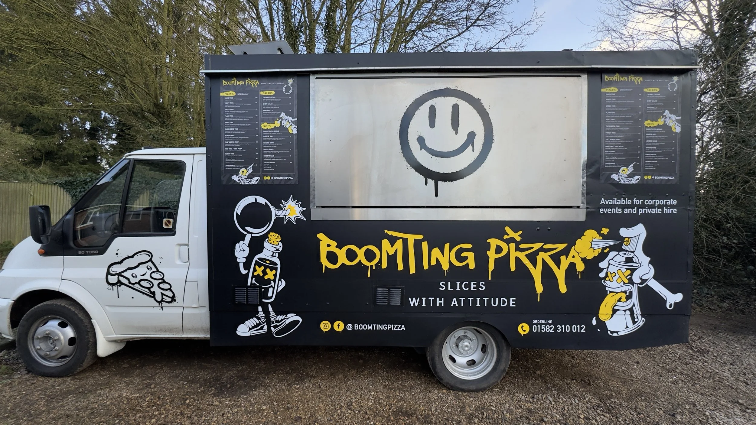Full serving side of Boomting Pizza food truck with menu boards and printed wrap graphics.jpeg