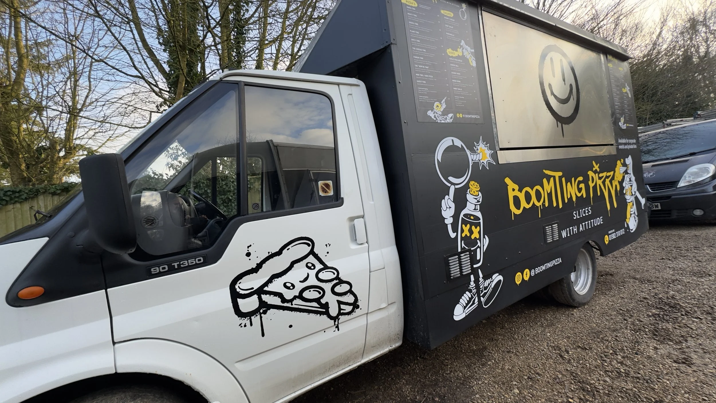 Rear-side angle of Boomting Pizza food truck wrap showing full body graphics.jpeg