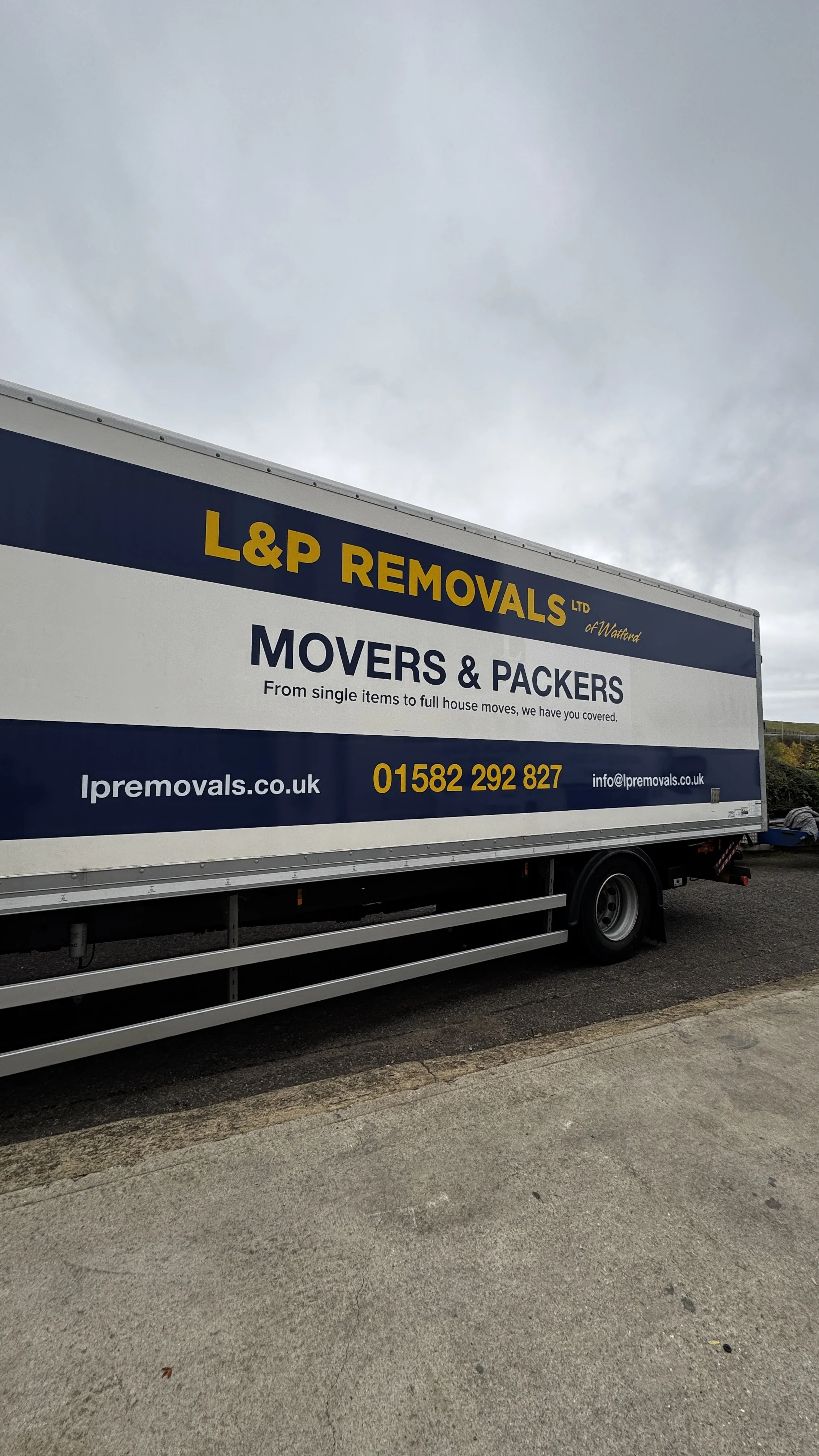 Full side view of L&P Removals branded lorry with large printed vehicle graphics in Bedfordshire.JPG