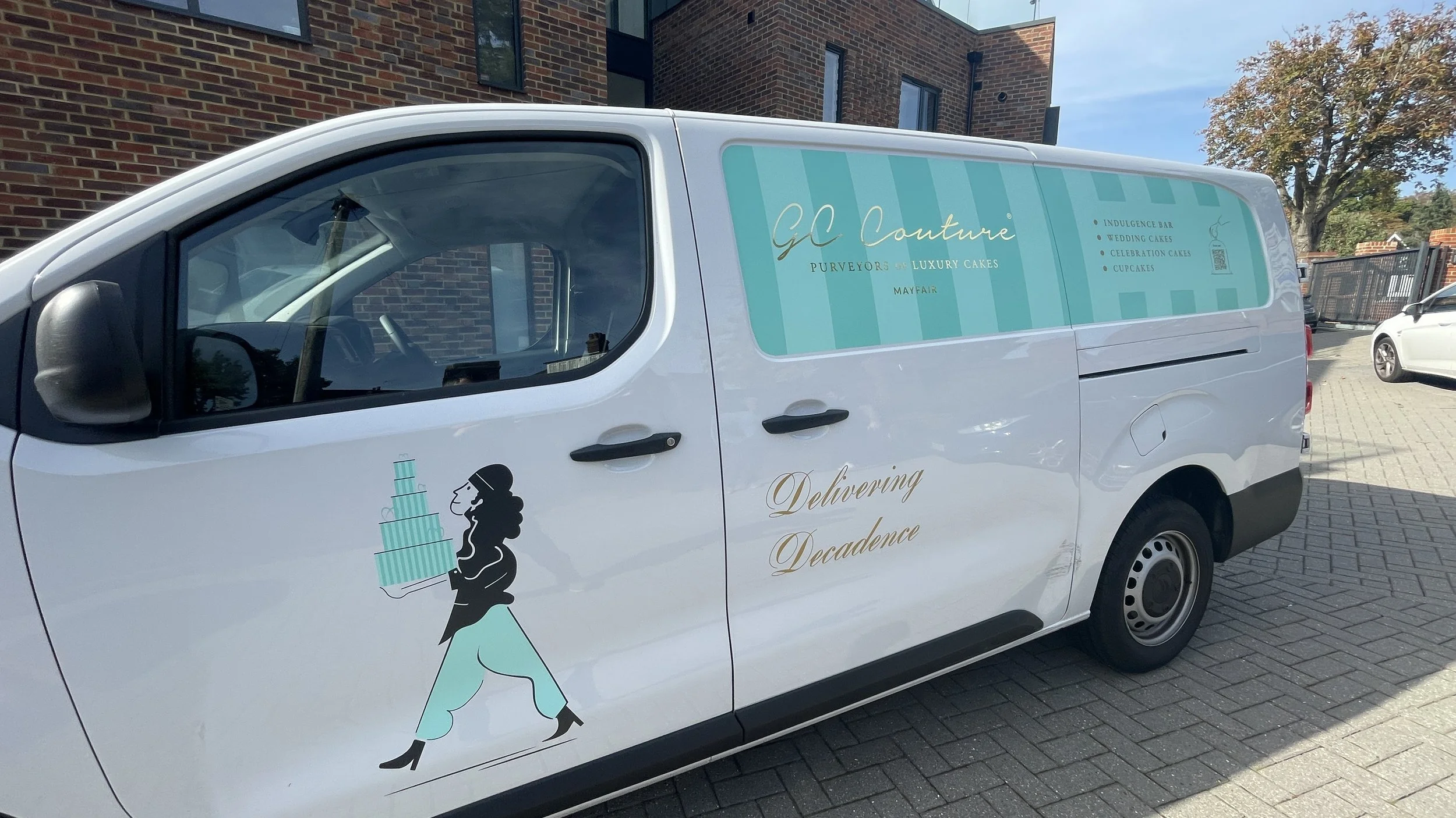Close-up of GC Couture bakery van graphics with cake illustration and gold-style lettering.JPG