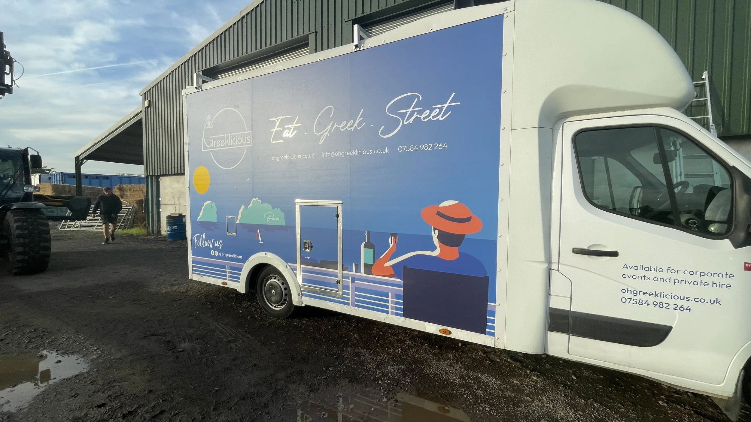 Custom Greek street food truck wrap featuring Mediterranean scenery, logo and contact details.JPG