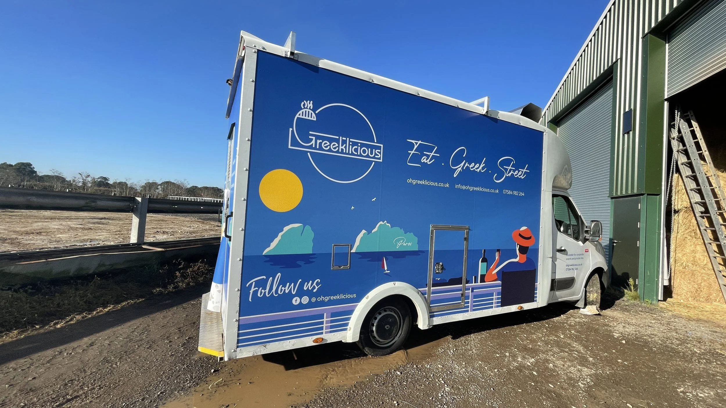 Oh Greeklicious illustrated food truck wrap with blue Greek island scenery in Windsor.JPG