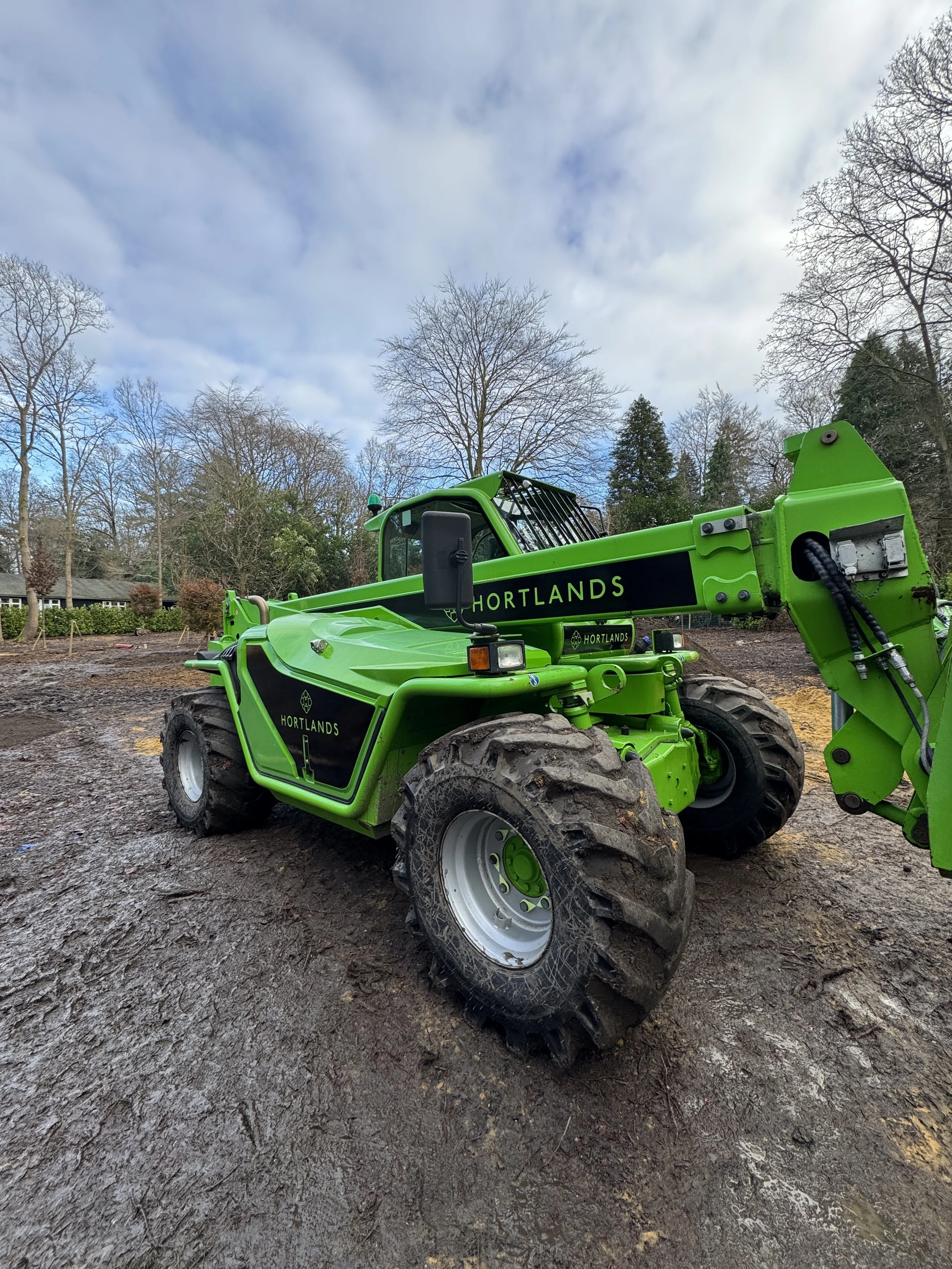 Hortlands telehandler with bespoke black and green machinery graphics on a landscaping site in Iver.JPG
