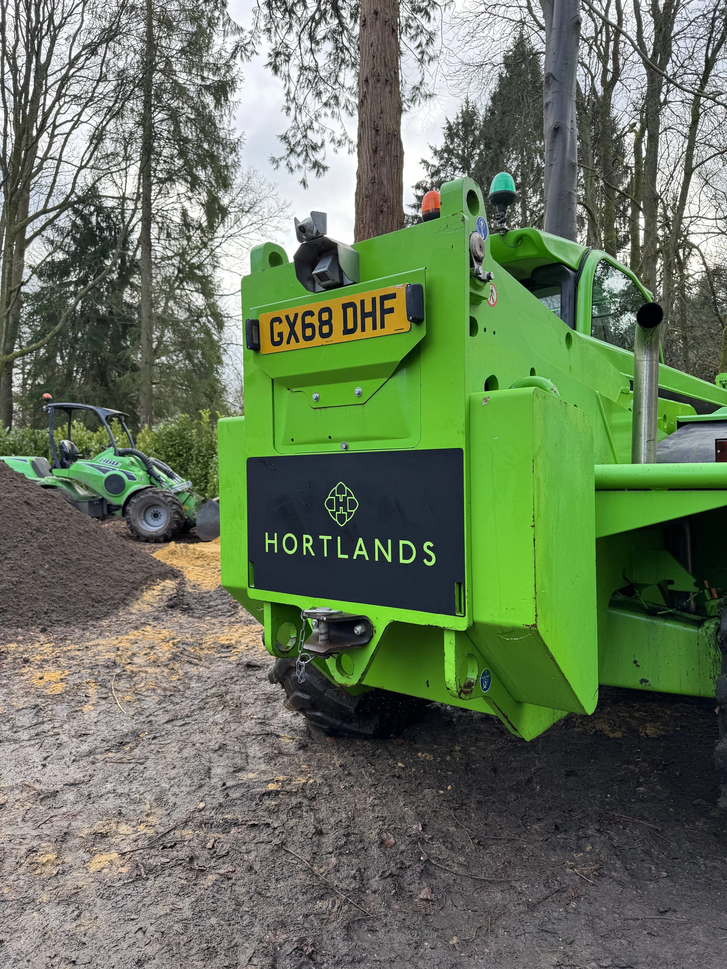 Rear of green telehandler with custom black Hortlands logo panel and printed vinyl graphics.JPG