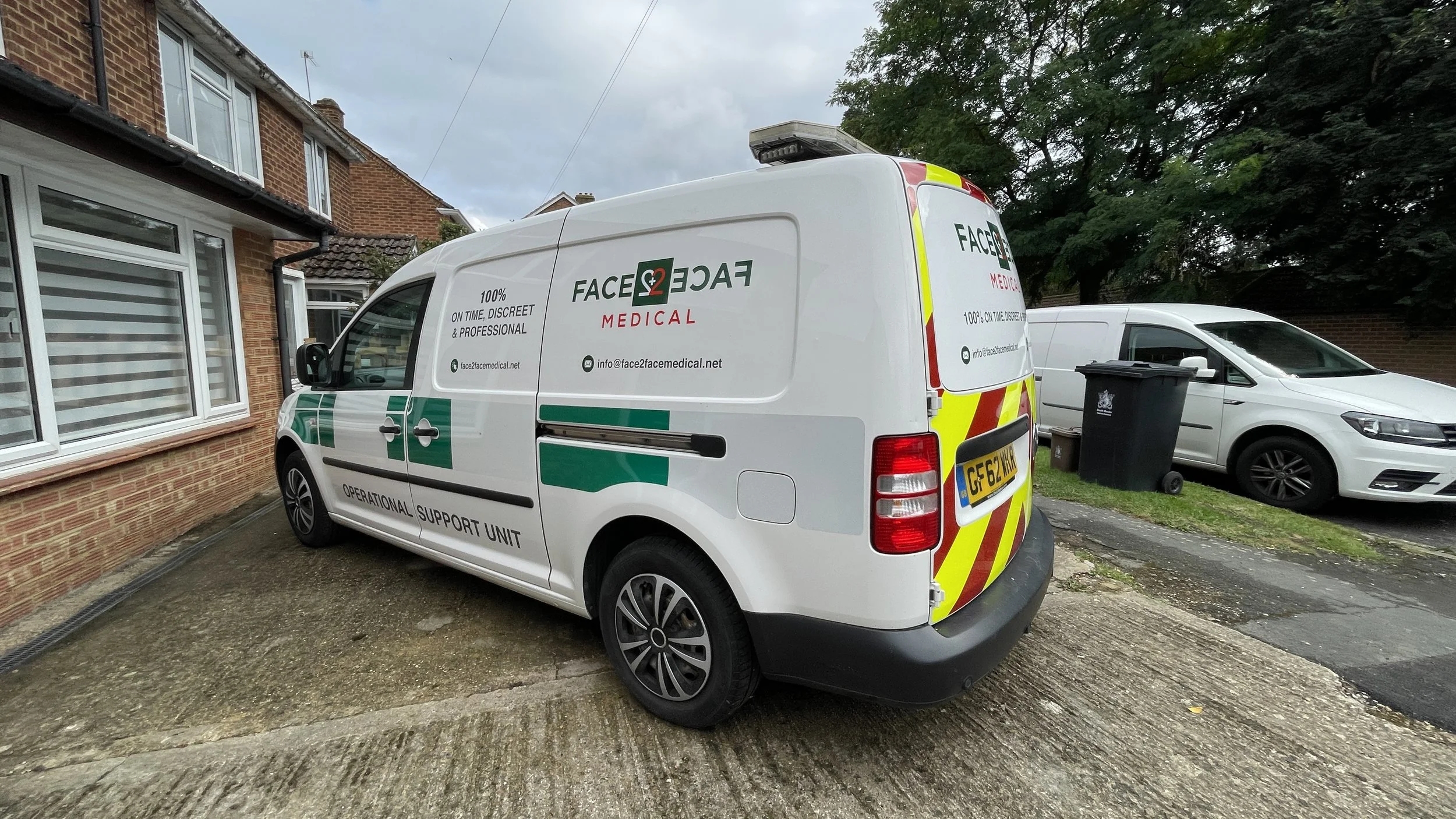 Face2Face Medical VW Caddy Maxi vehicle livery with green graphics and high-visibility rear chevrons in Slough.JPG