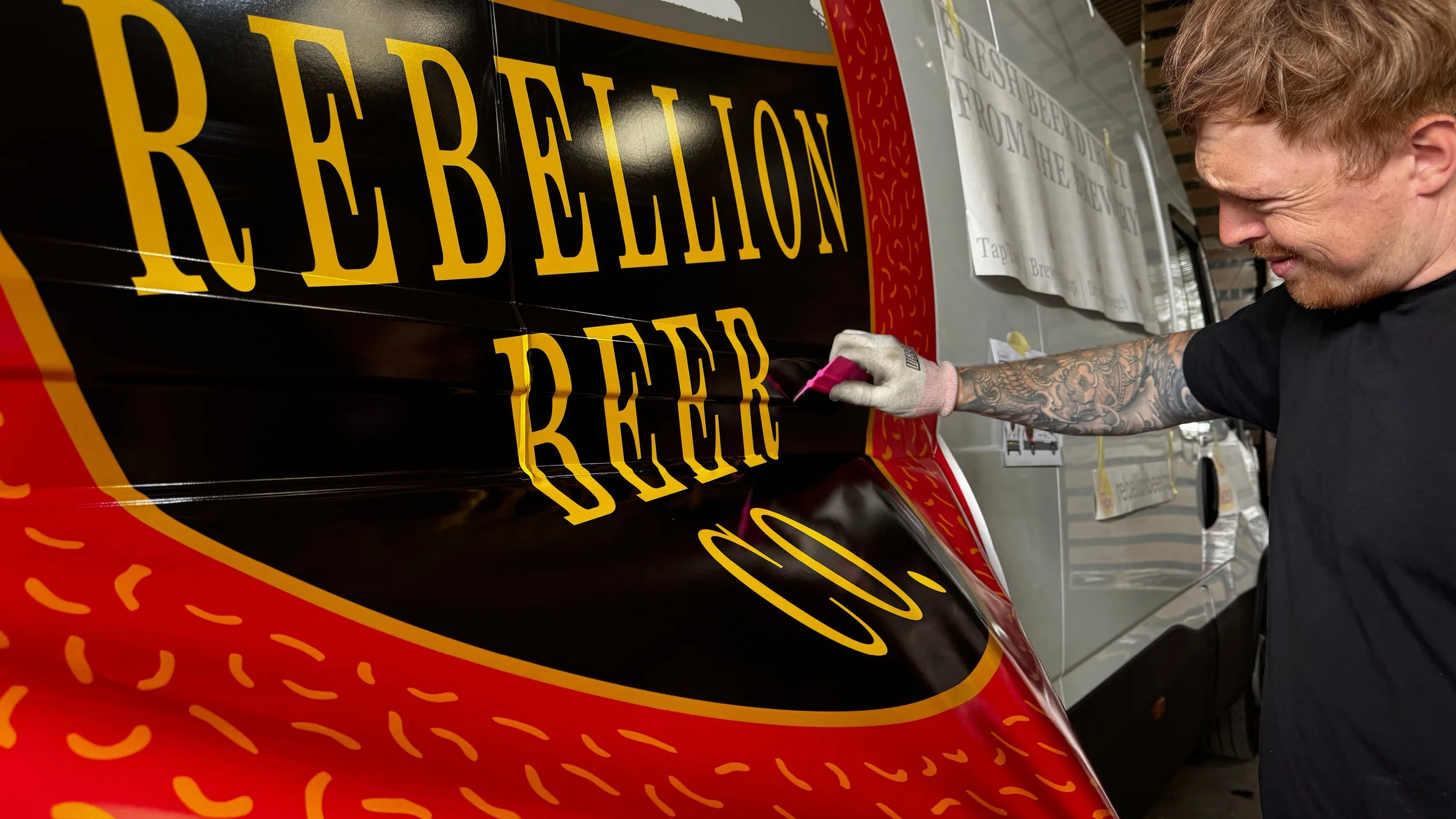 Large Rebellion Beer Van signage being installed by toy creative.jpg