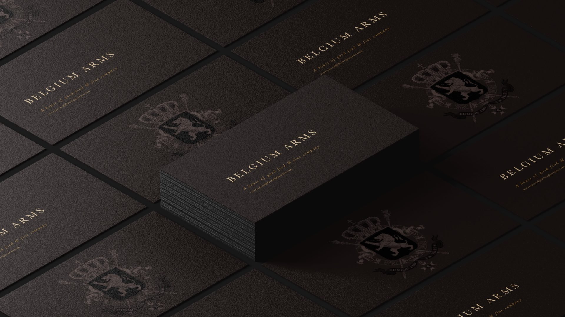 Black business cards with gold embossed text reading 'Belgium Arms' and a crest featuring a lion and crown.