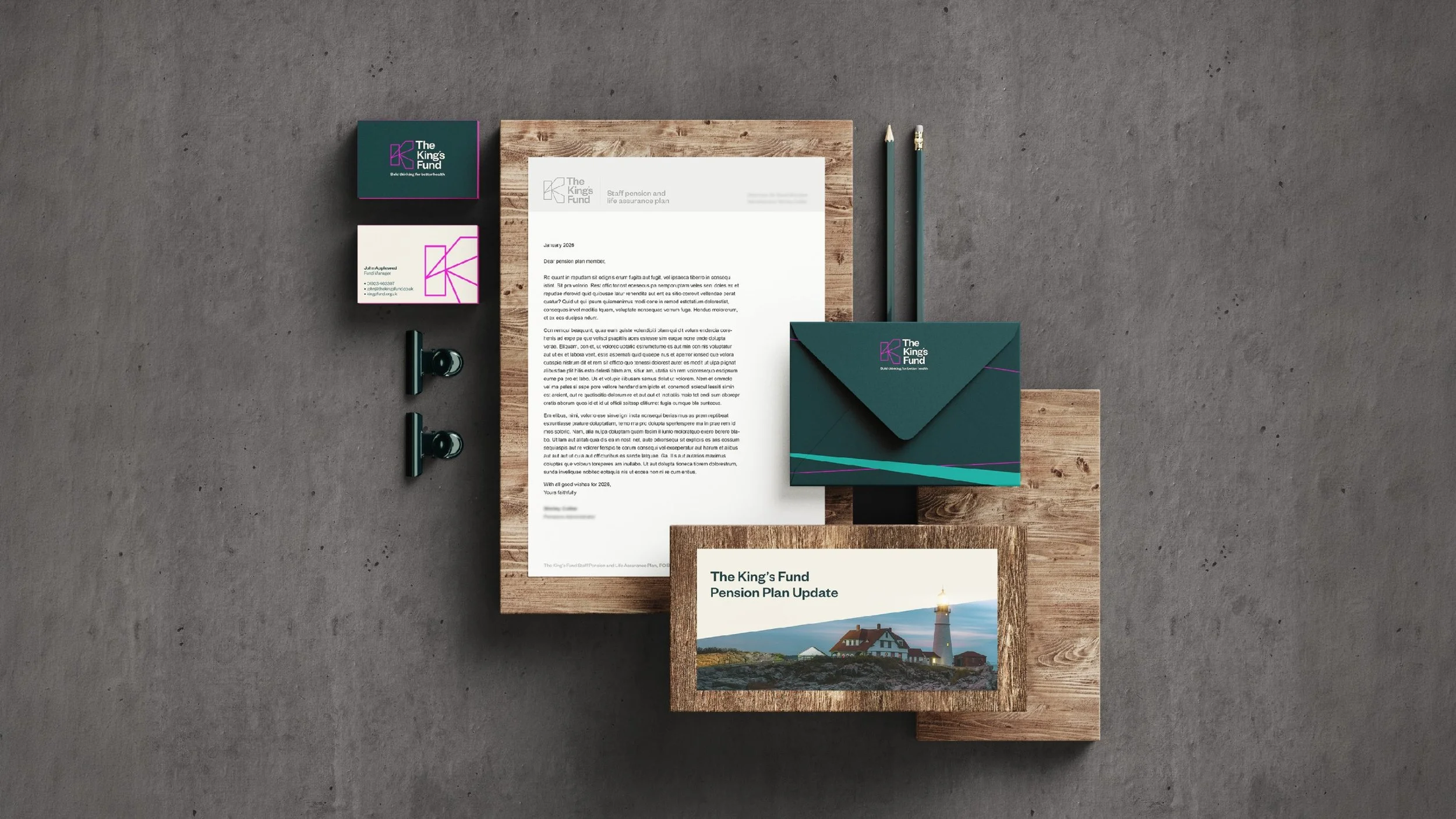 Flat lay of professional stationery and printed materials on a concrete surface, including business cards, letterhead, envelope, folder, and pens, branded for 'The King's Fund' with logo and design elements in purple and teal.