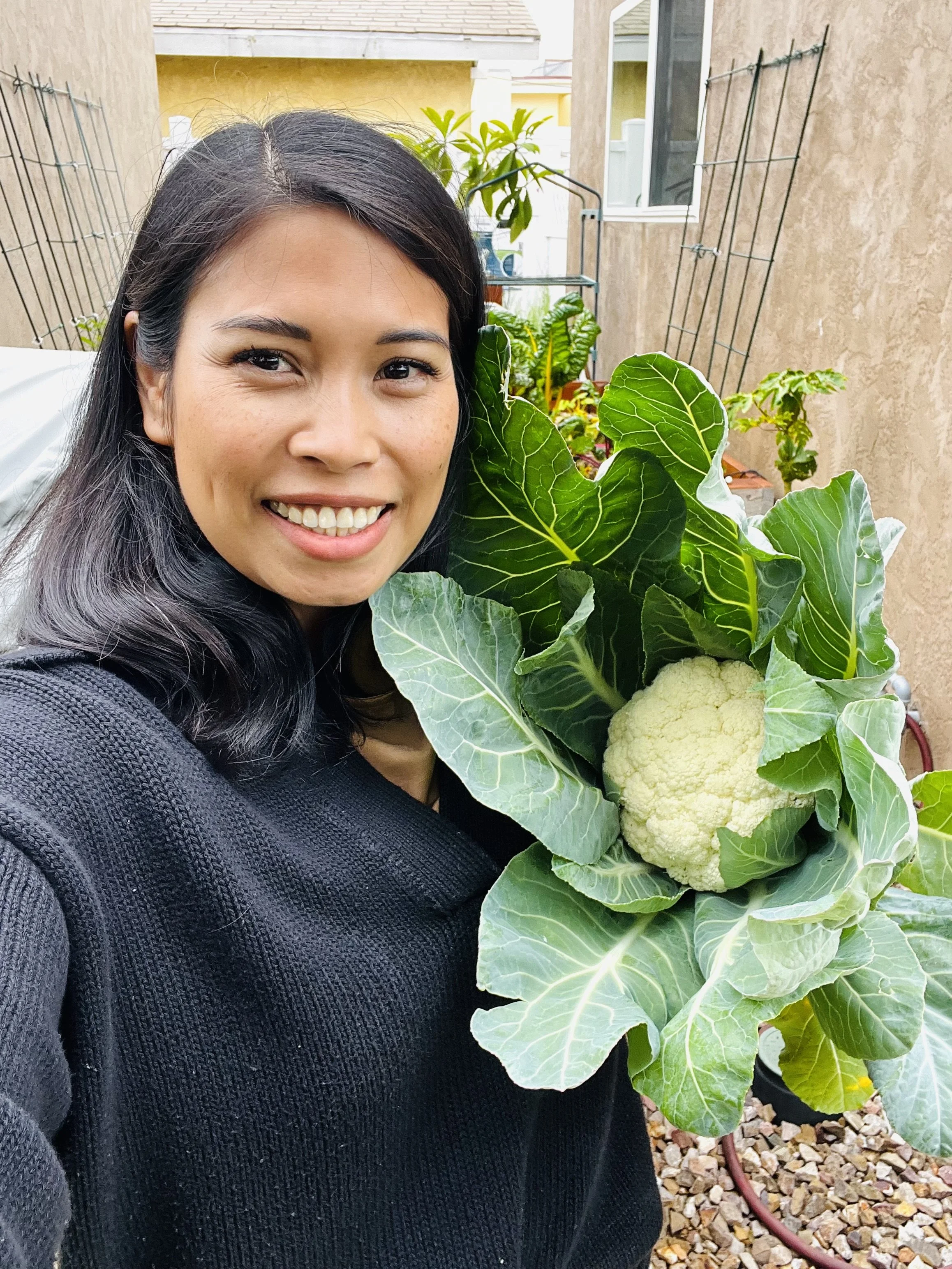 woman holding freshly cut cauliflower