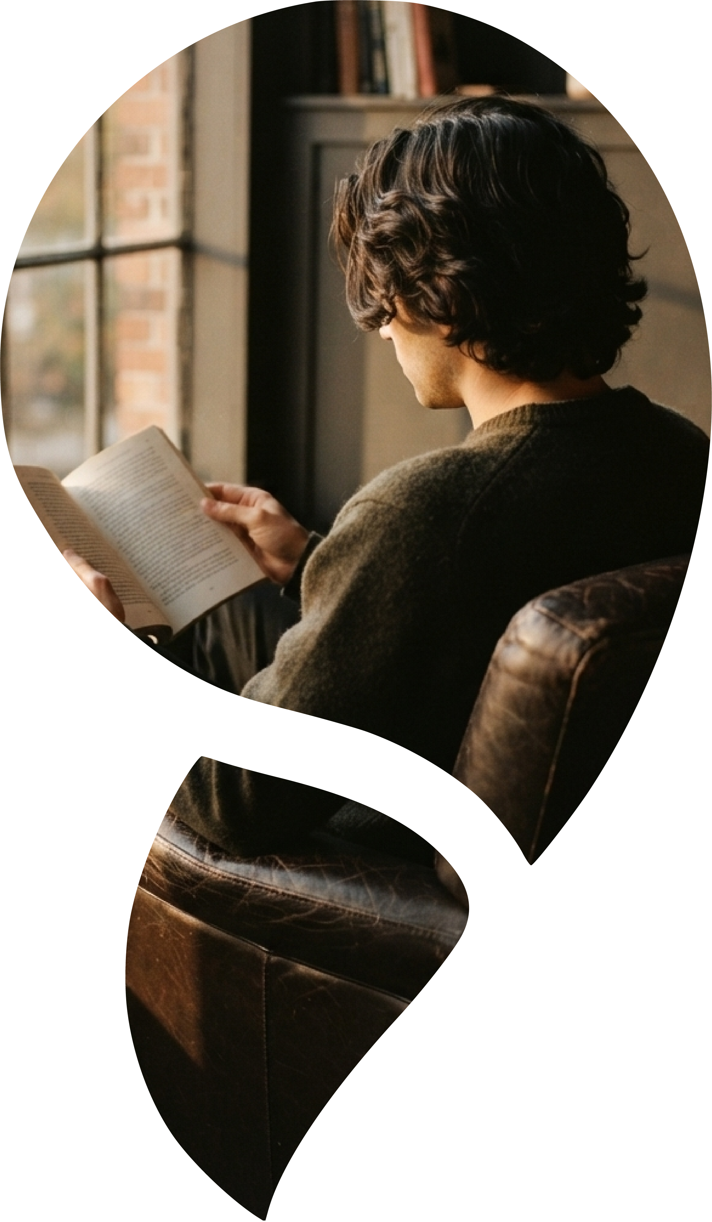 Person reading beside a window in a quiet room, representing reflection and psychological insight.
