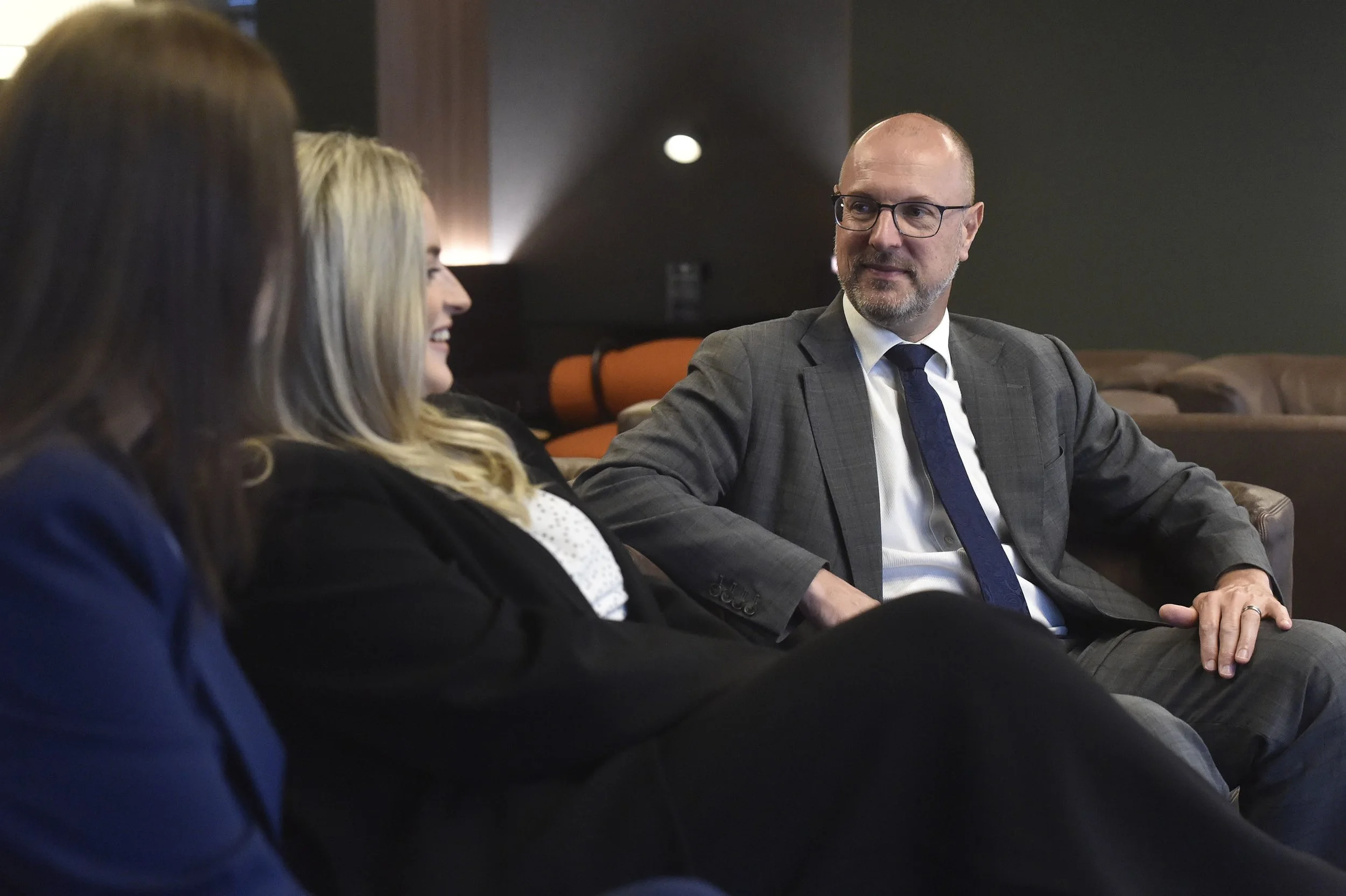 Workable Law partners Suzy Cusack, Matthew Robinson and Suzy Cusack sitting on a sofa