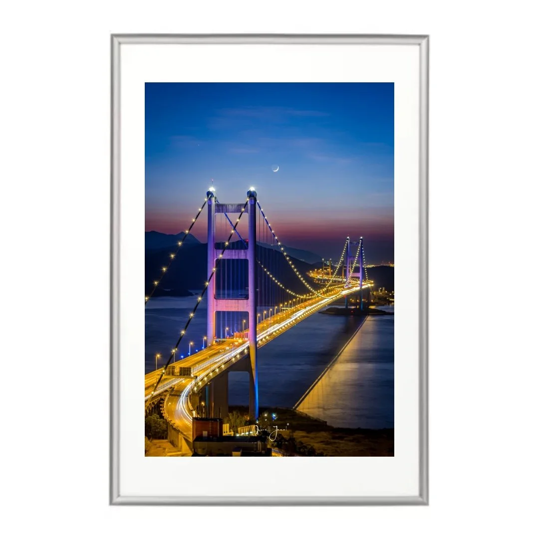 Vertical fine art print of a bridge lit up at night with long exposure traffic trails.