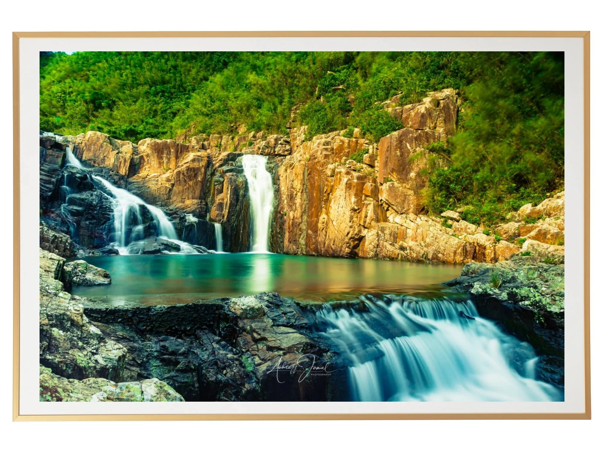 Framed fine art print mockup of a long-exposure waterfall landscape in Sai Kung, Hong Kong, presented in a thin golden frame on a white wall.