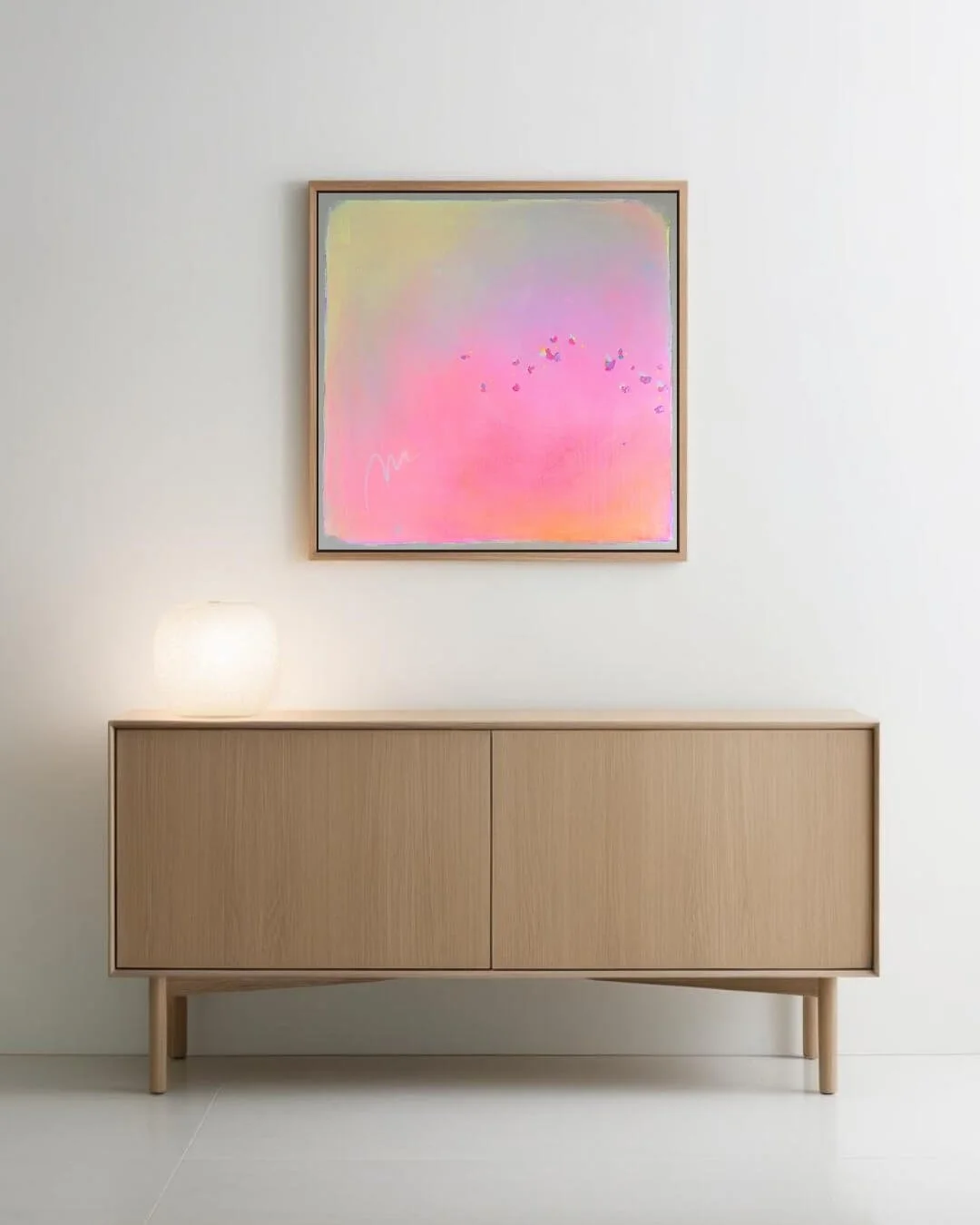 Modern living room featuring the large pastel pink abstract painting Summer Breeze mounted on a bright interior wall