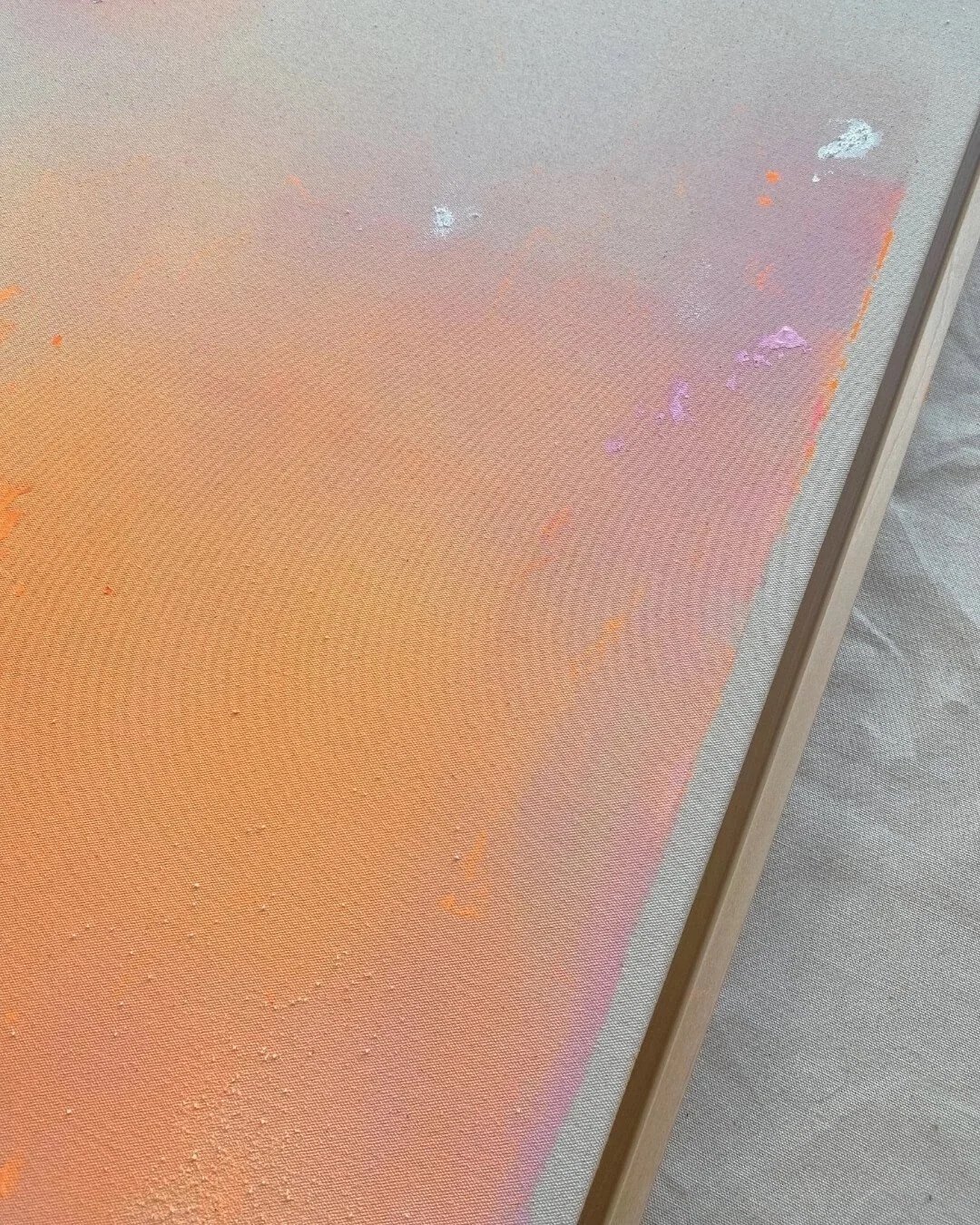 Detail shot showing the soft blending of orange, rose, and pink paint with subtle texture and dripping effects by Vanessa Ochi