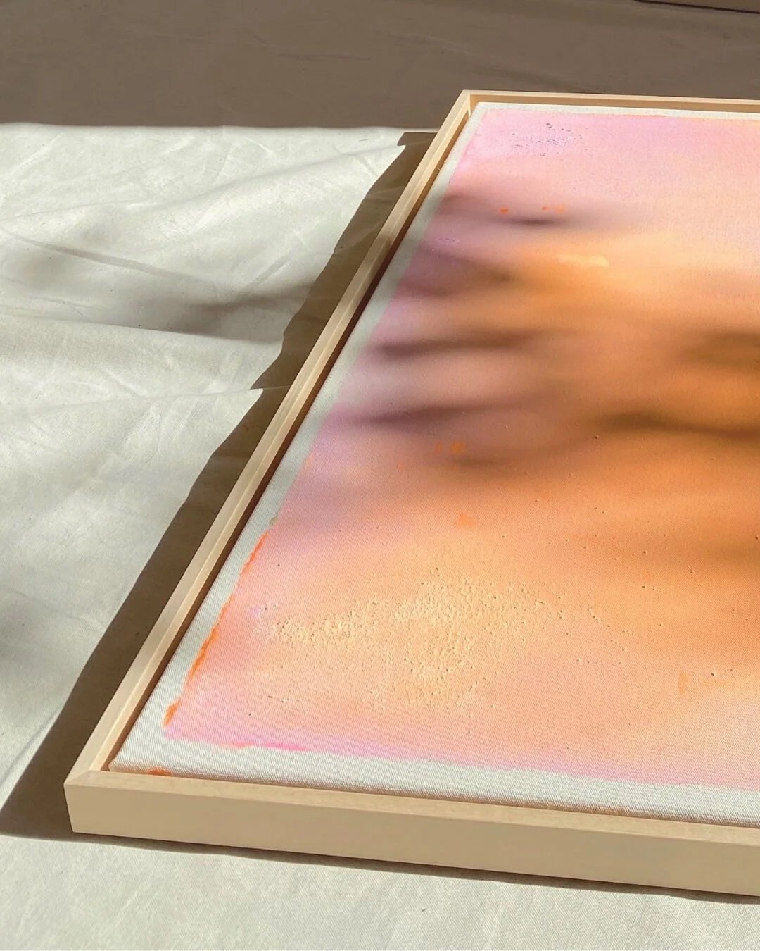 Detail shot showing the soft blending of orange, rose, and pink paint with subtle texture and dripping effects by Vanessa Ochi