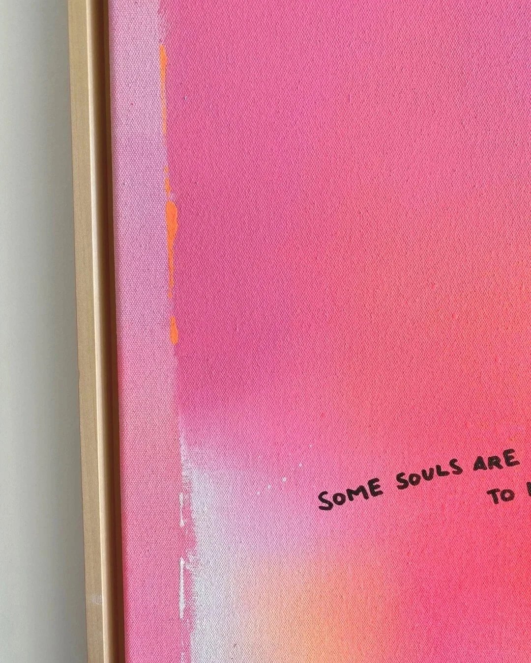 Close-up detail of the written text 'Some souls are meant to meet - again and again, forever' over radiant neon orange and pink gradients by Vanessa Ochi