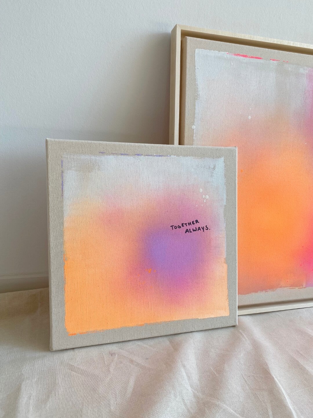 Luminous canvas artwork in electric neon orange and purple tones displaying typography about timeless connection by Vanessa Ochi.