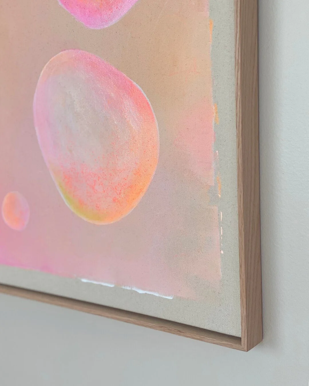 Close-up detail of smooth-gradient bubbles in soft pink, beige, and orange on a textured canvas by Vanessa Ochi.